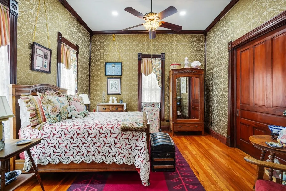 Secondary bedroom off front entry with custom upholstered walls.