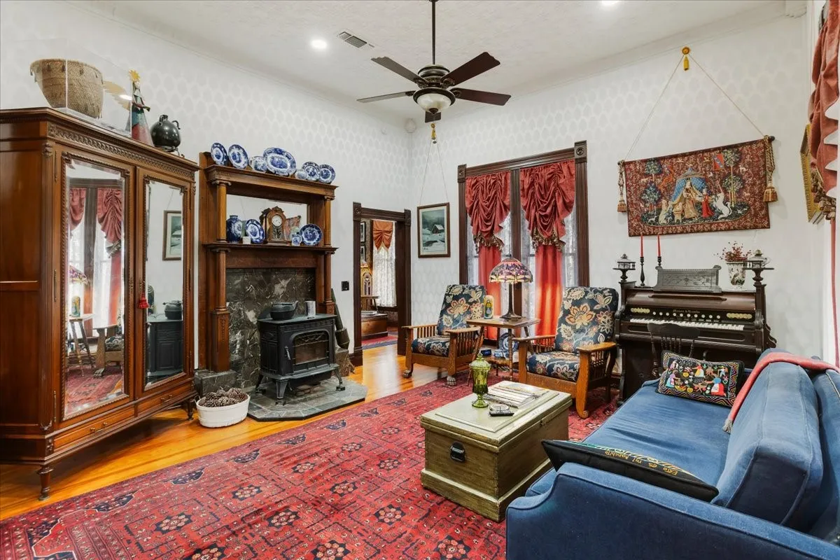 Open living area with custom upholstered walls throughout.