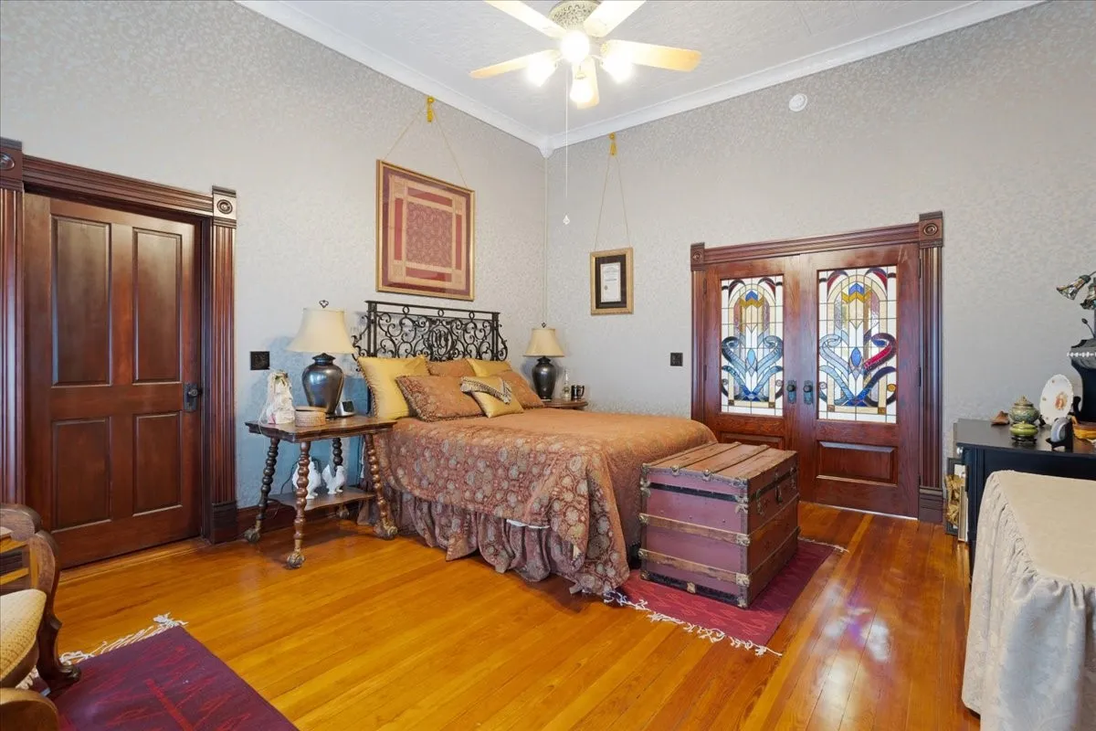 View of primary bedroom with beautiful stained glass pocket doors.