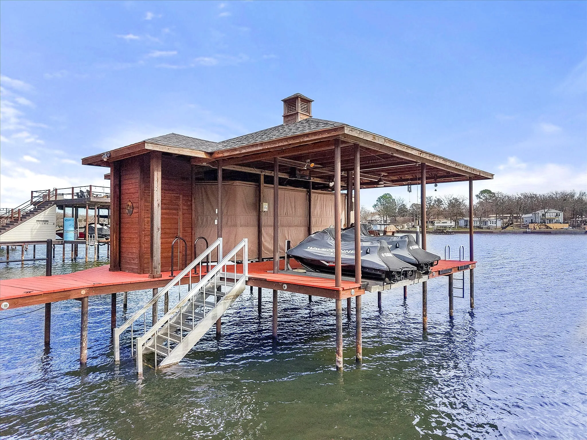 Dock area featuring boat lift and a water view
