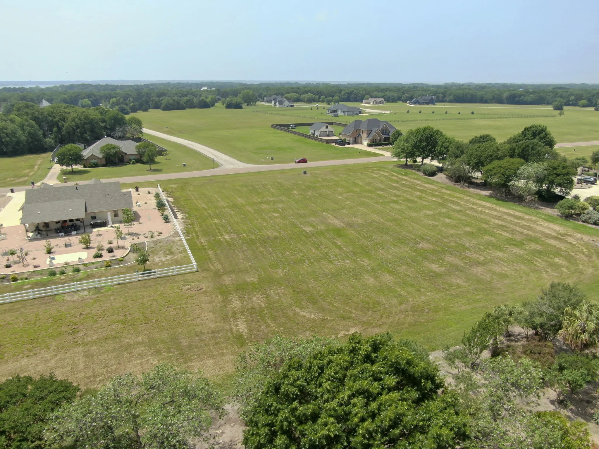 Expansive green lot featuring a broad, level terrain