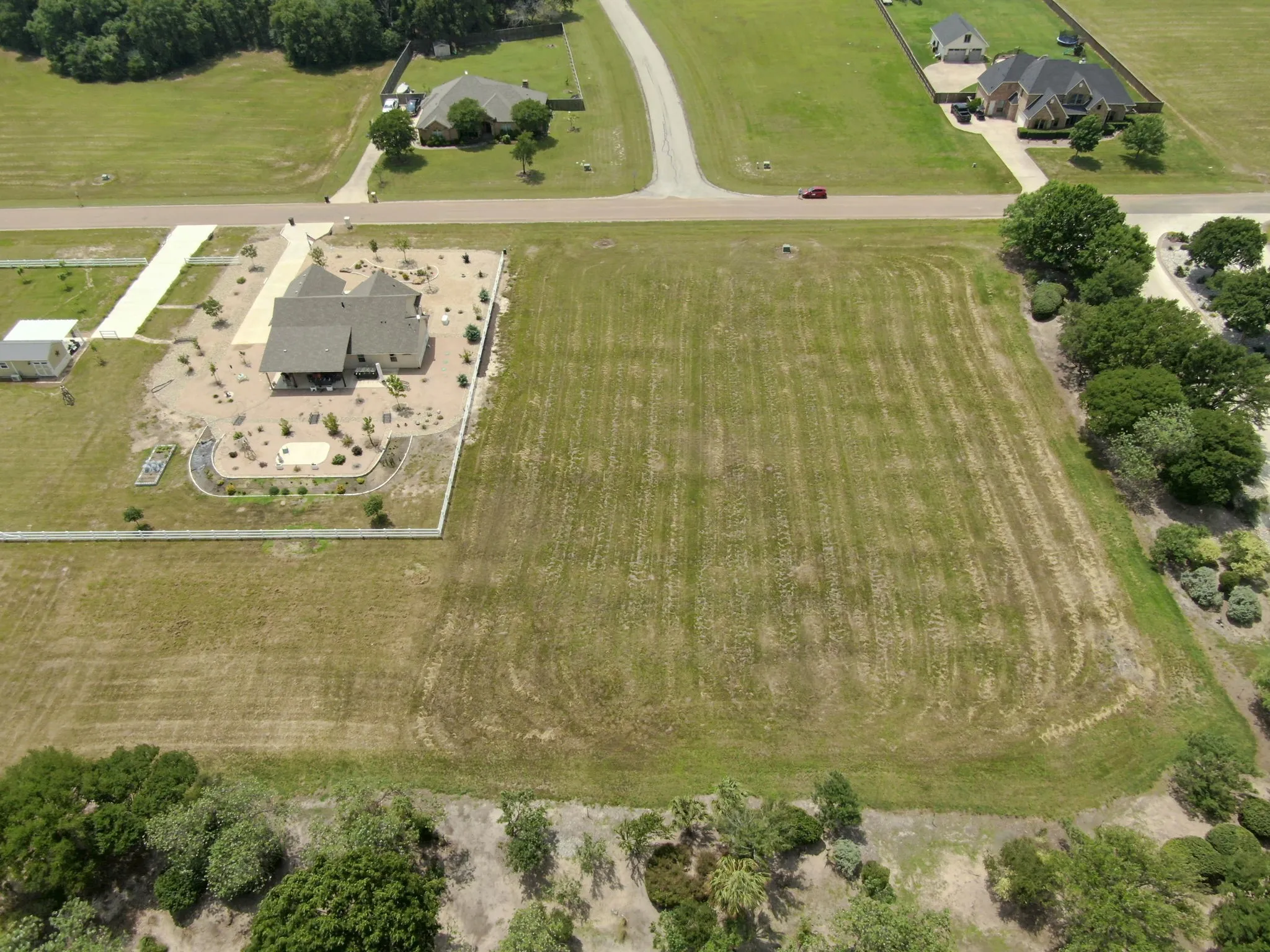 Expansive cleared lot with perimeter landscaping