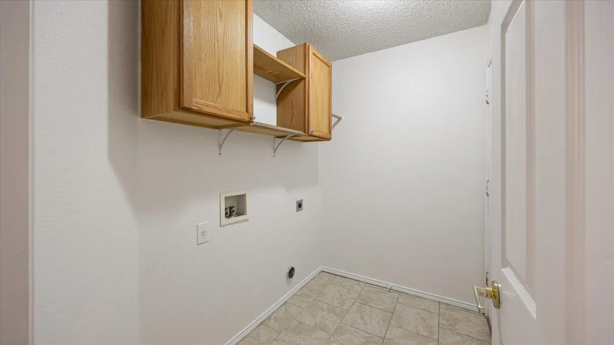 Plenty of space for full-size washer and drying, with door to garage.