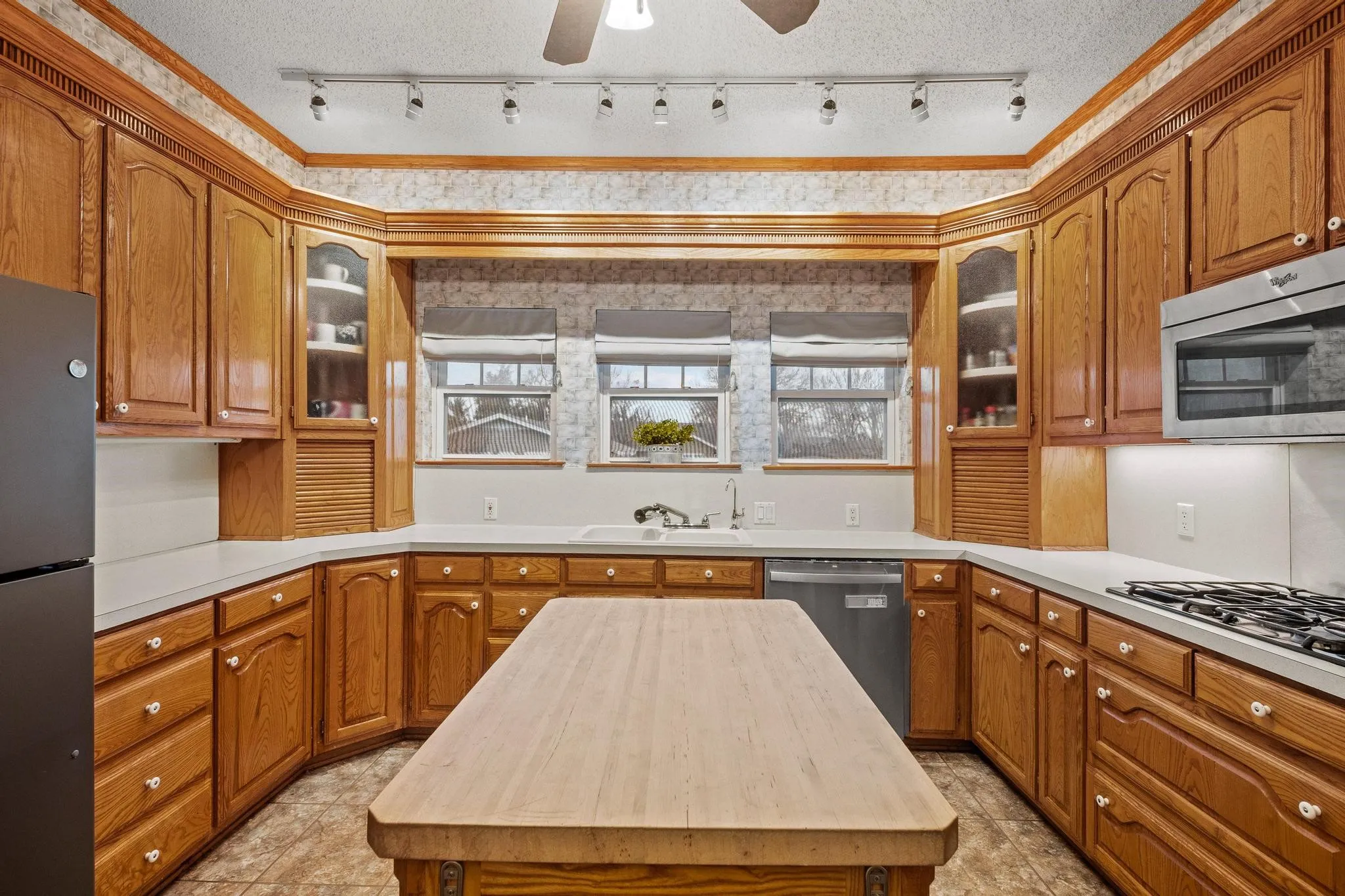 Custom solid wood cabinetry offers plenty of storage space in the large kitchen
