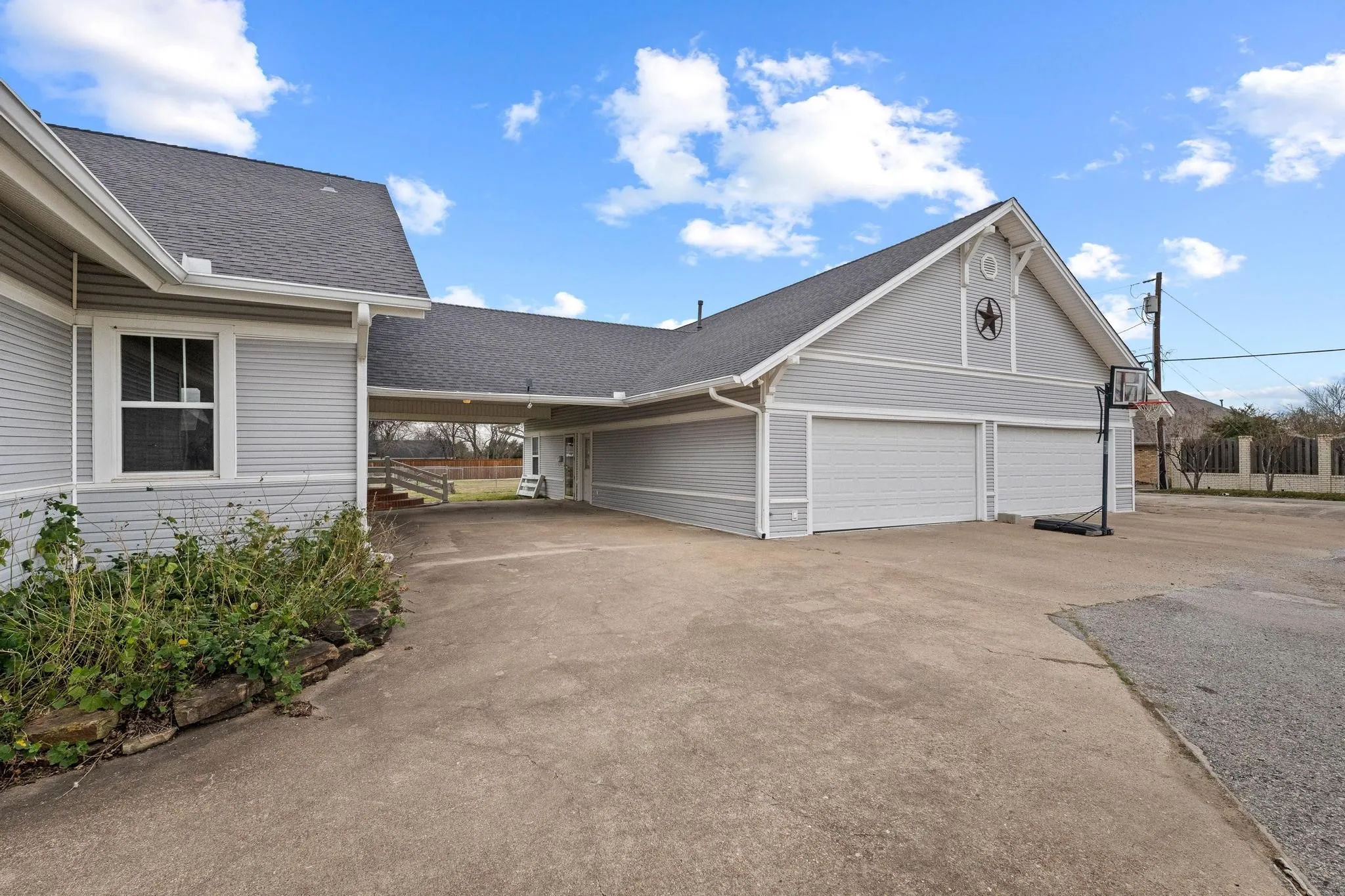 View of 4 car garage with separate entrance to guest quarters/apartment (ADU) at rear