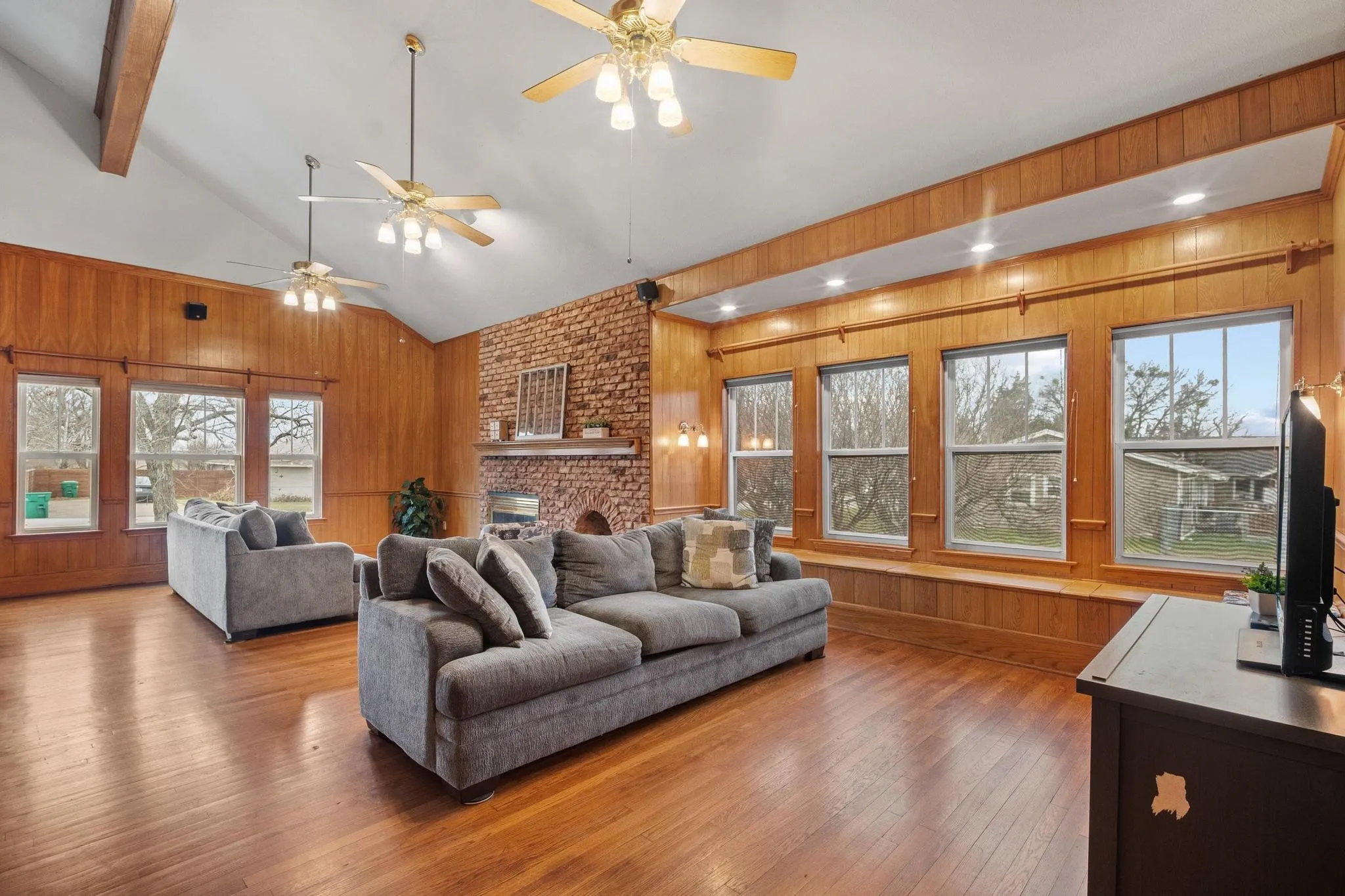 Lots of windows and vaulted ceiling flood the living/dining area with light