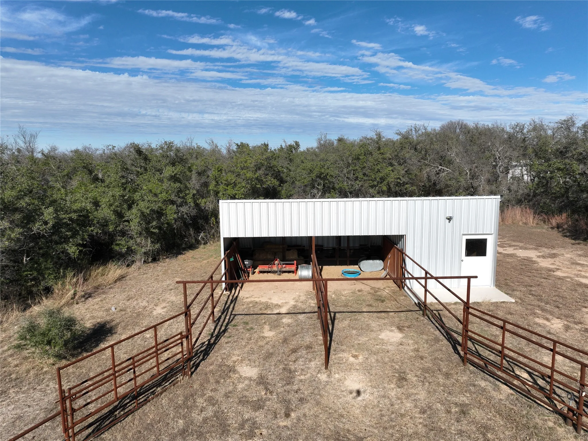 Horse barn, two stalls with runs, tack room and feed storage.