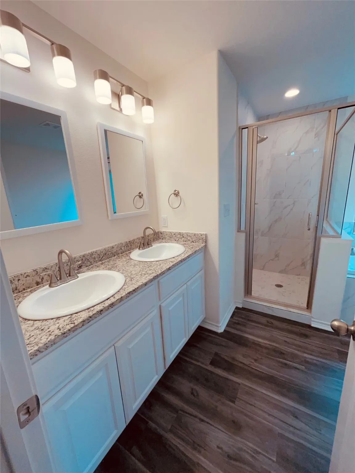 Masterbath featuring double vanity, a tile finish shower, and recessed lighting