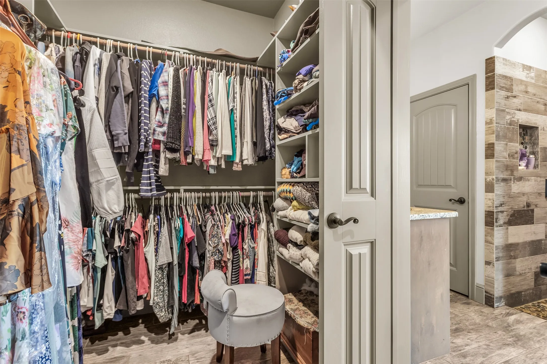 Walk in closet featuring arched walkways