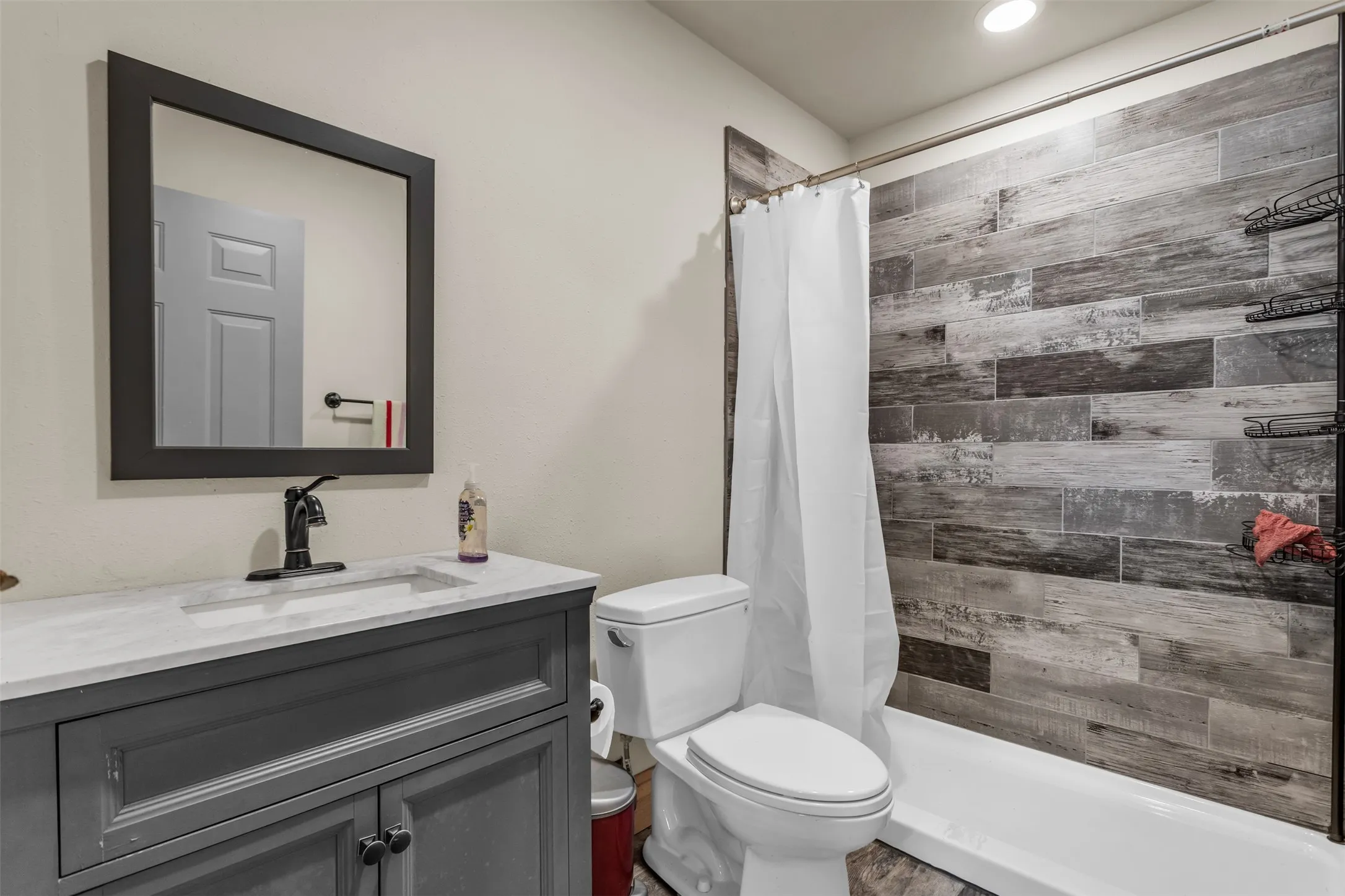 Full bath with a stall shower and vanity