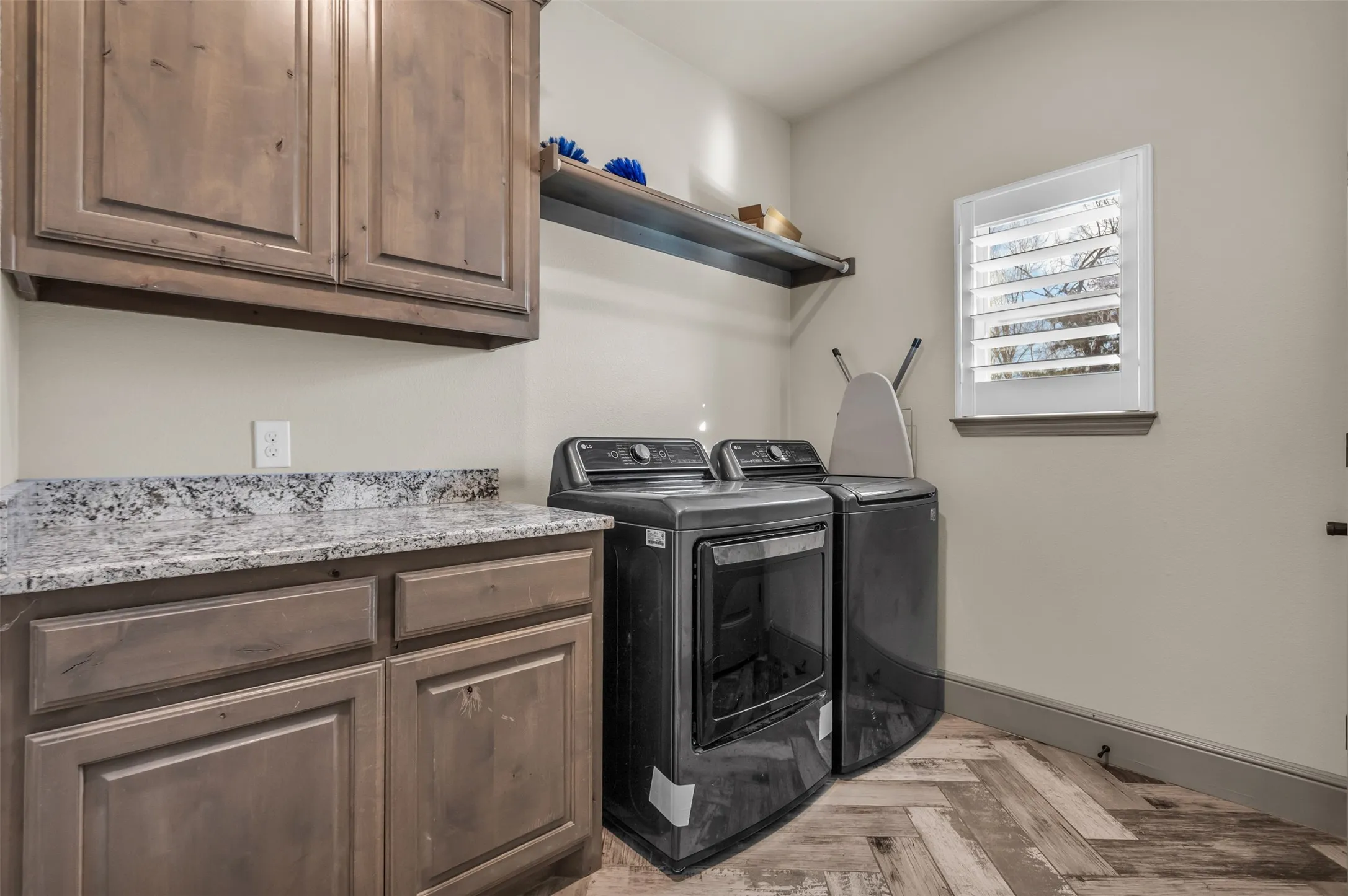 Washroom featuring independent washer and dryer and cabinet space