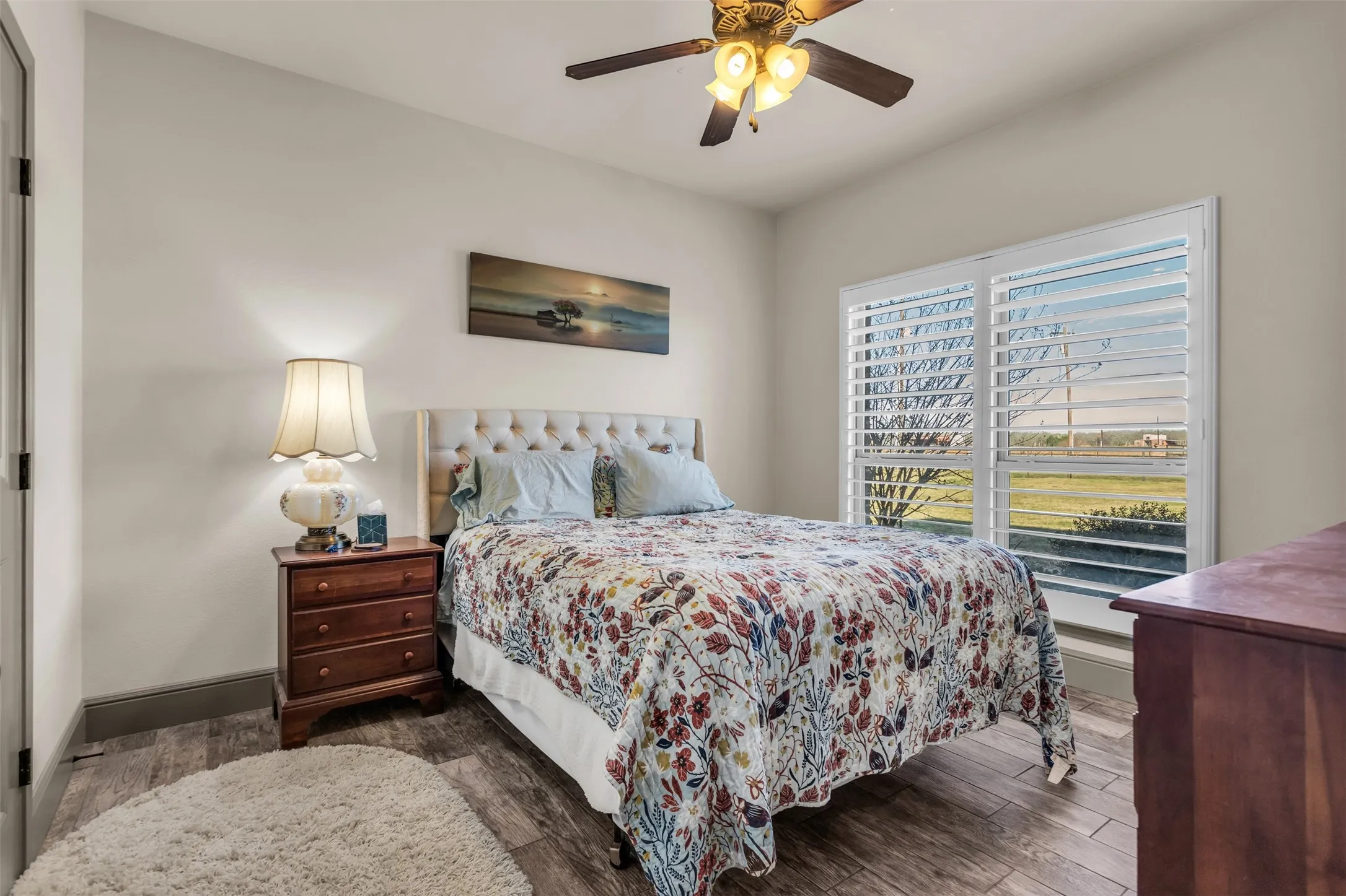 Bedroom with wood finished floors and a ceiling fan