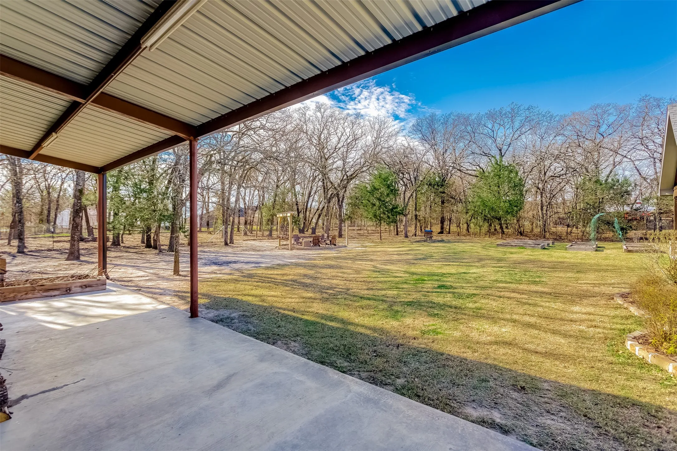 View of grassy yard featuring a patio