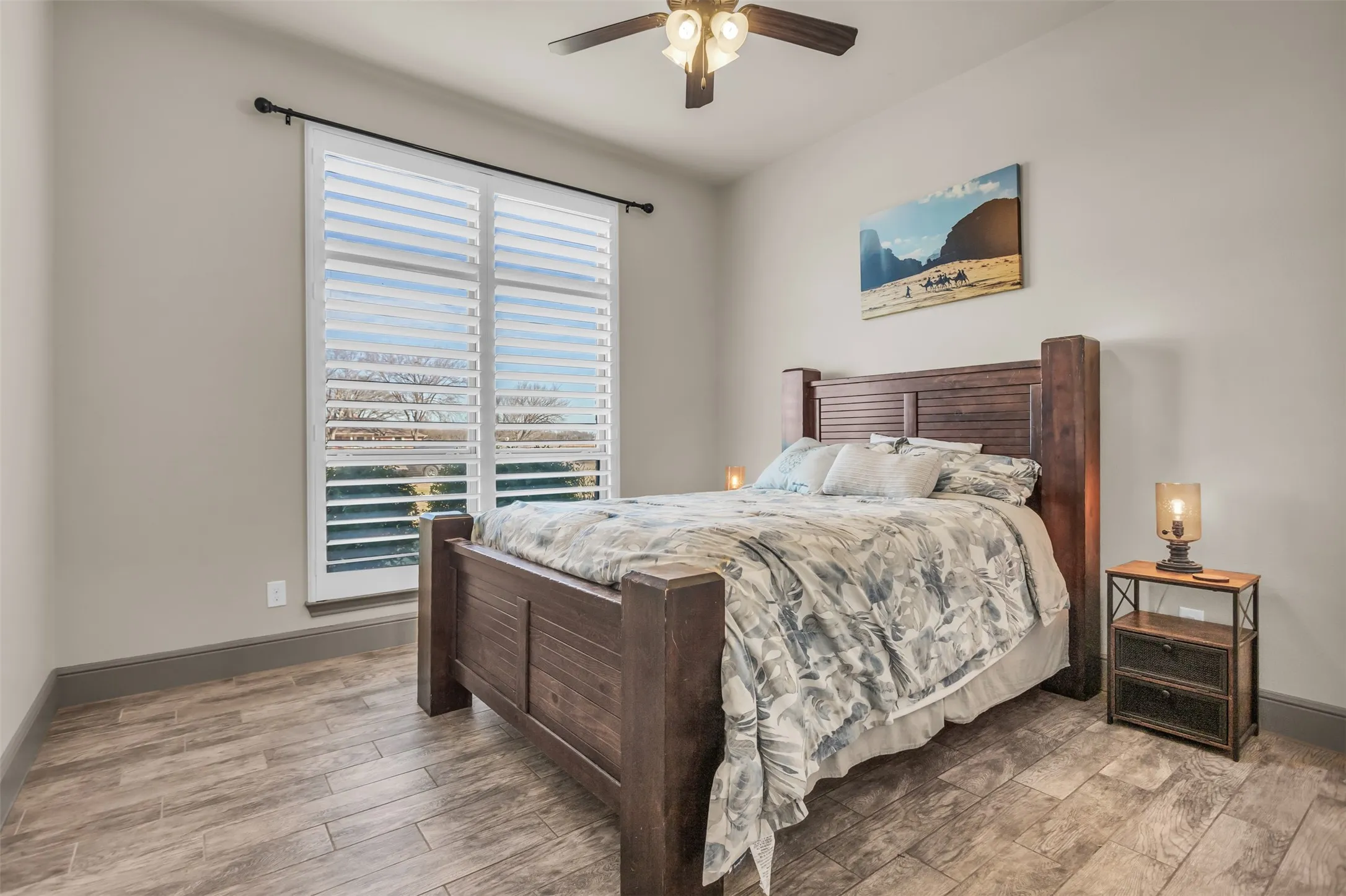 Bedroom with ceiling fan and light wood-type flooring