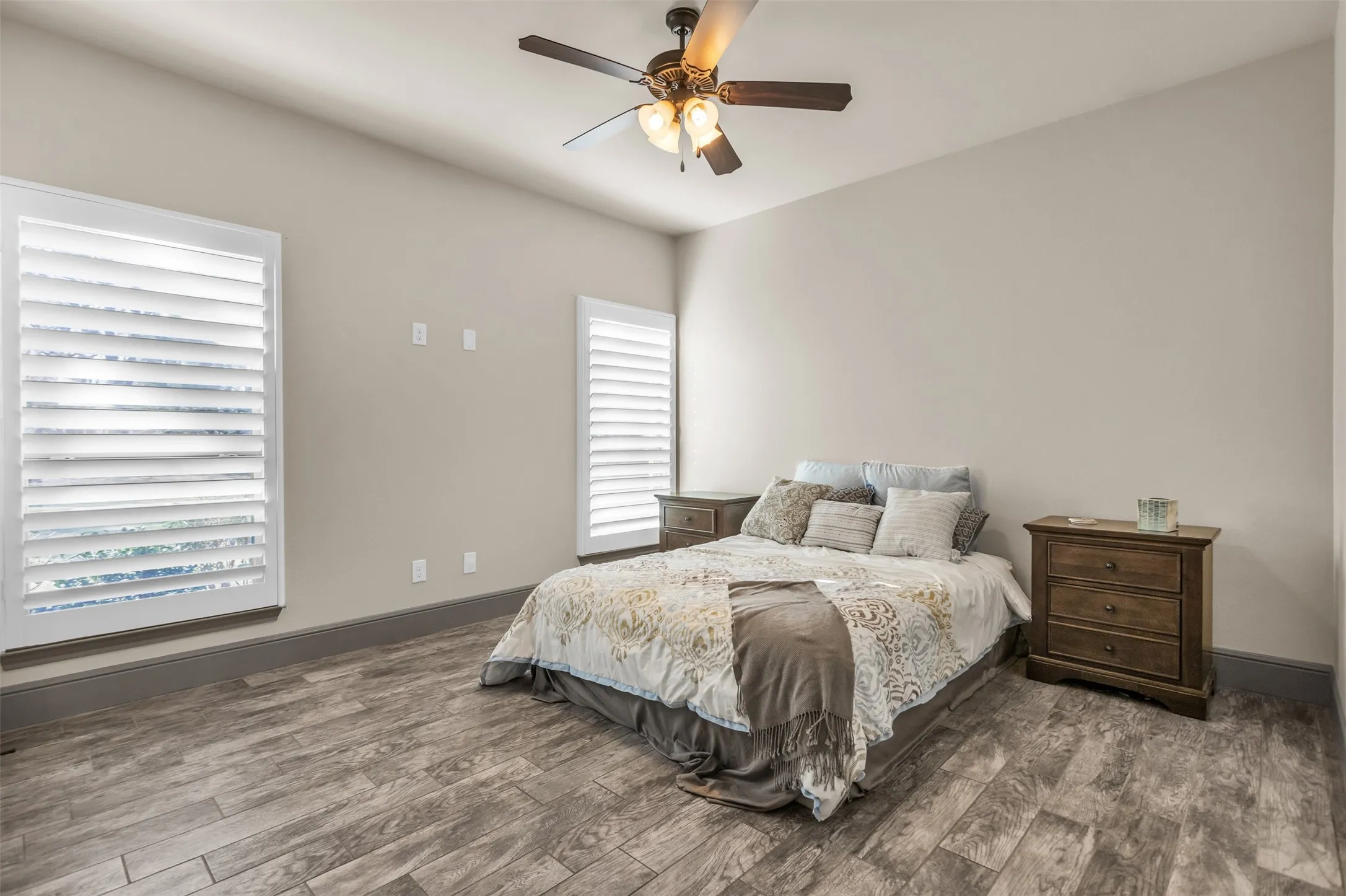 Bedroom featuring dark wood-type flooring and a ceiling fan