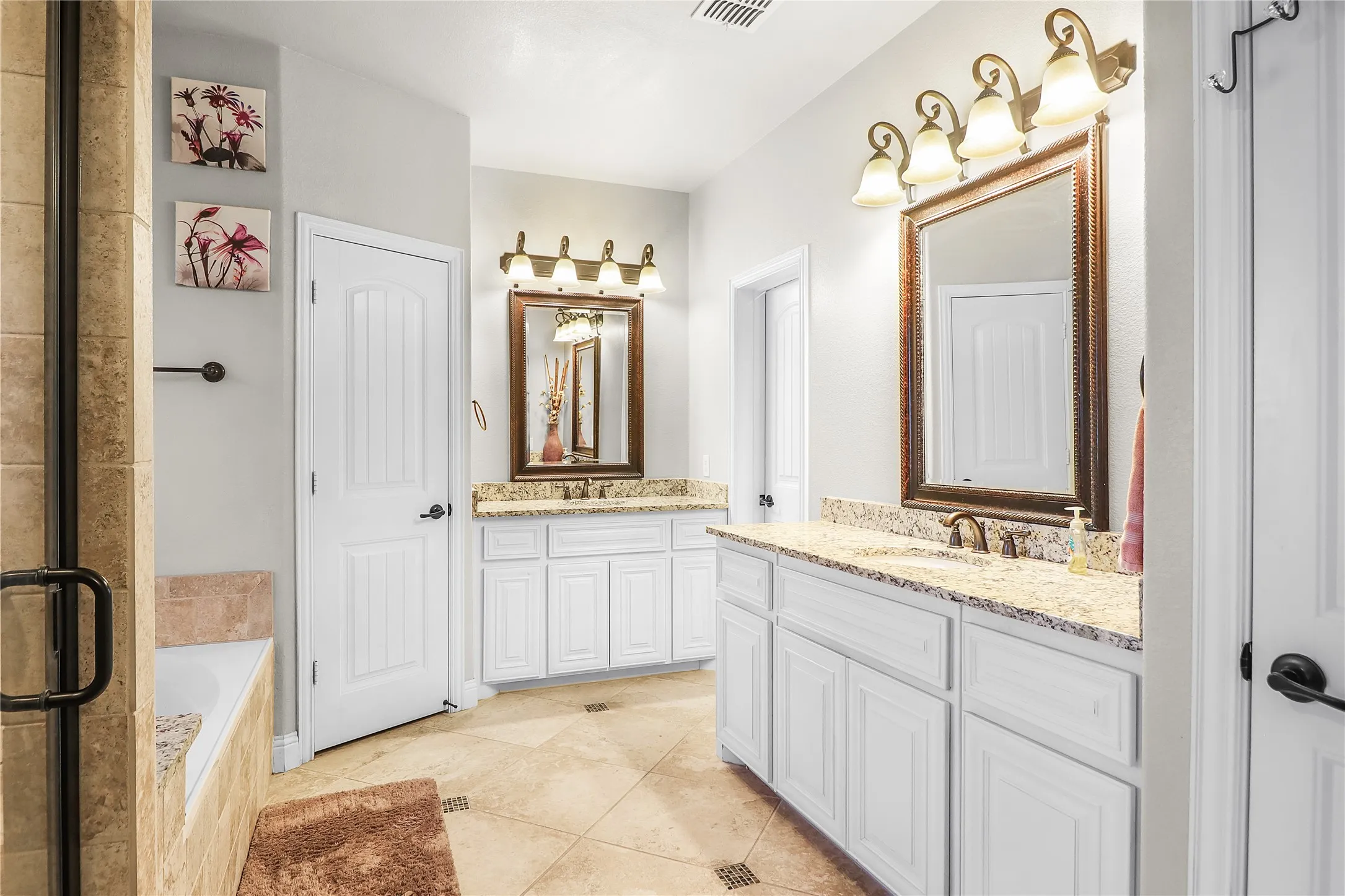 master bath with separate vanities and separate shower.