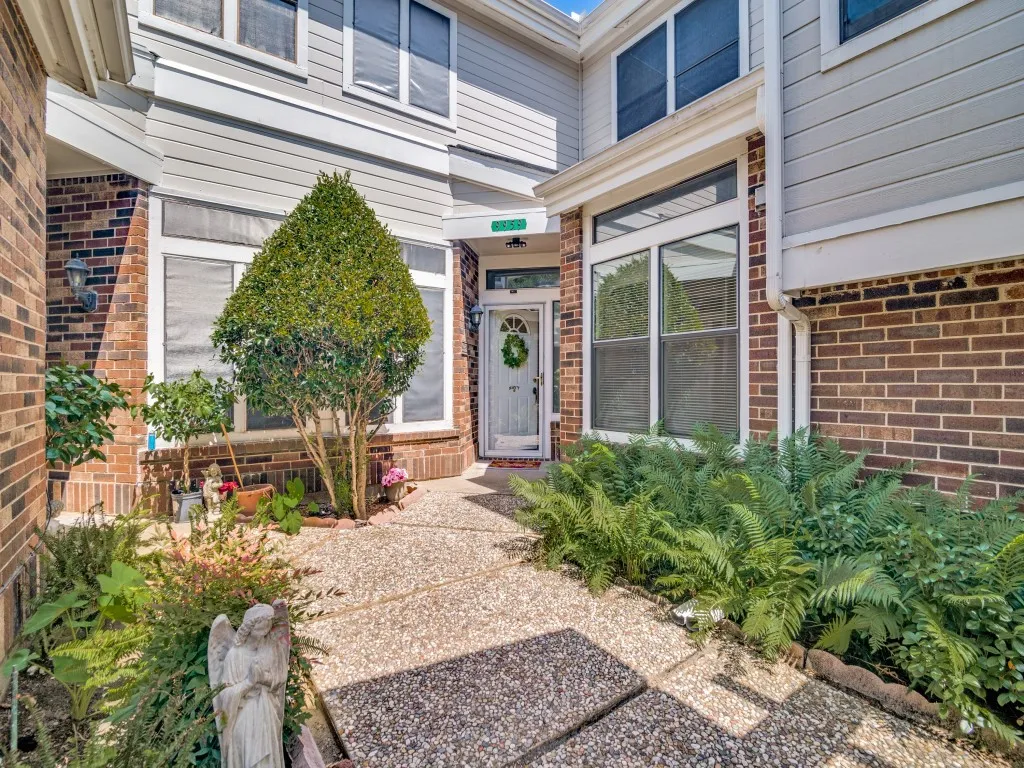 Entrance to property featuring brick siding
