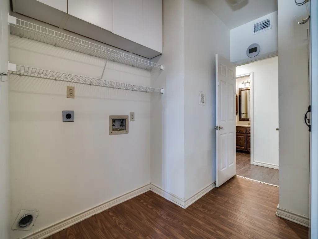 Washroom with electric dryer hookup, dark wood-style floors, and washer hookup