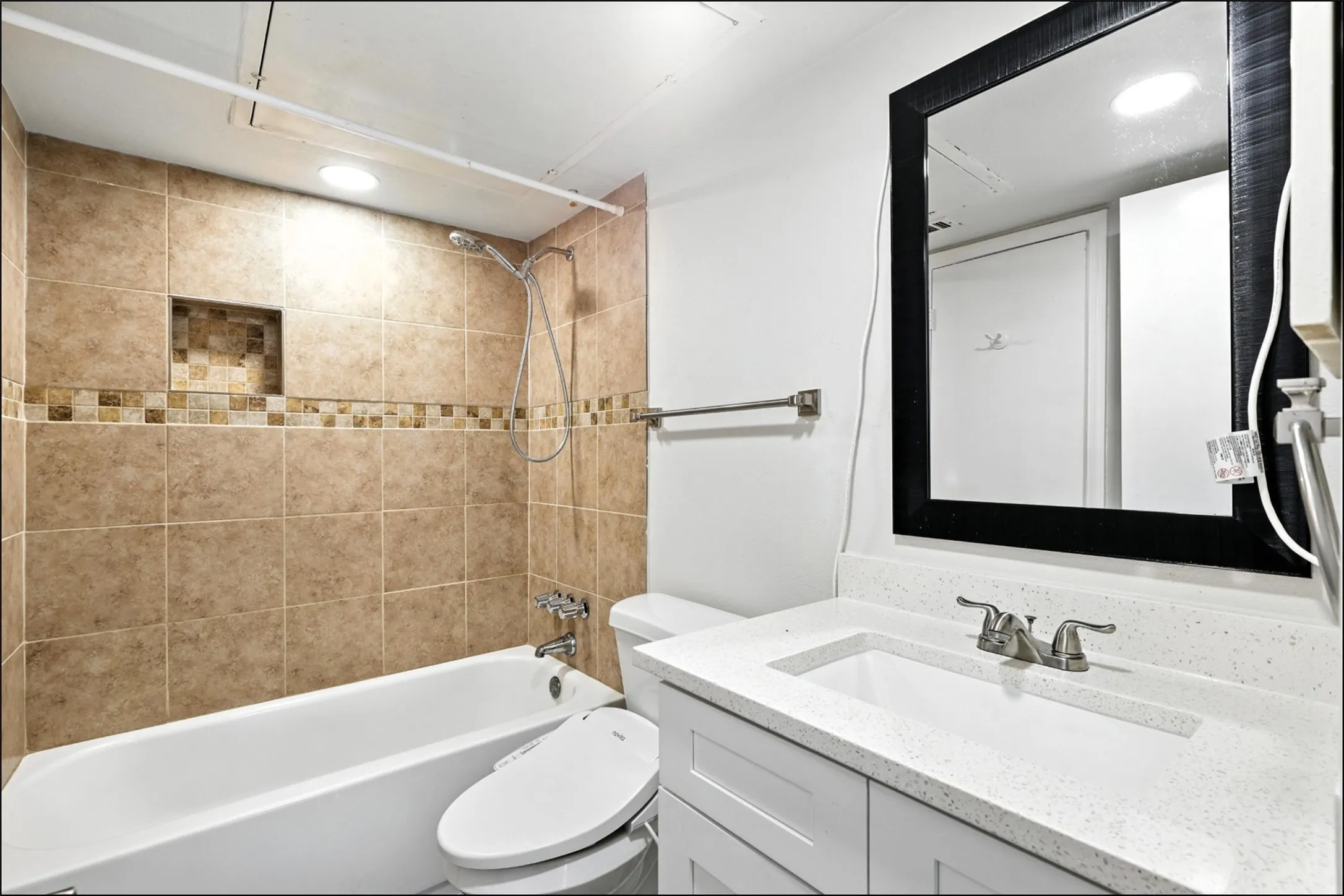 Bathroom featuring vanity and  shower combination