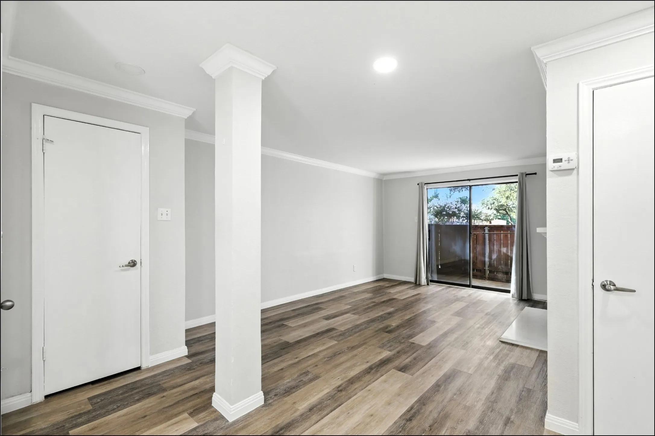 Spare room with crown molding, wood finished floors, and recessed lighting