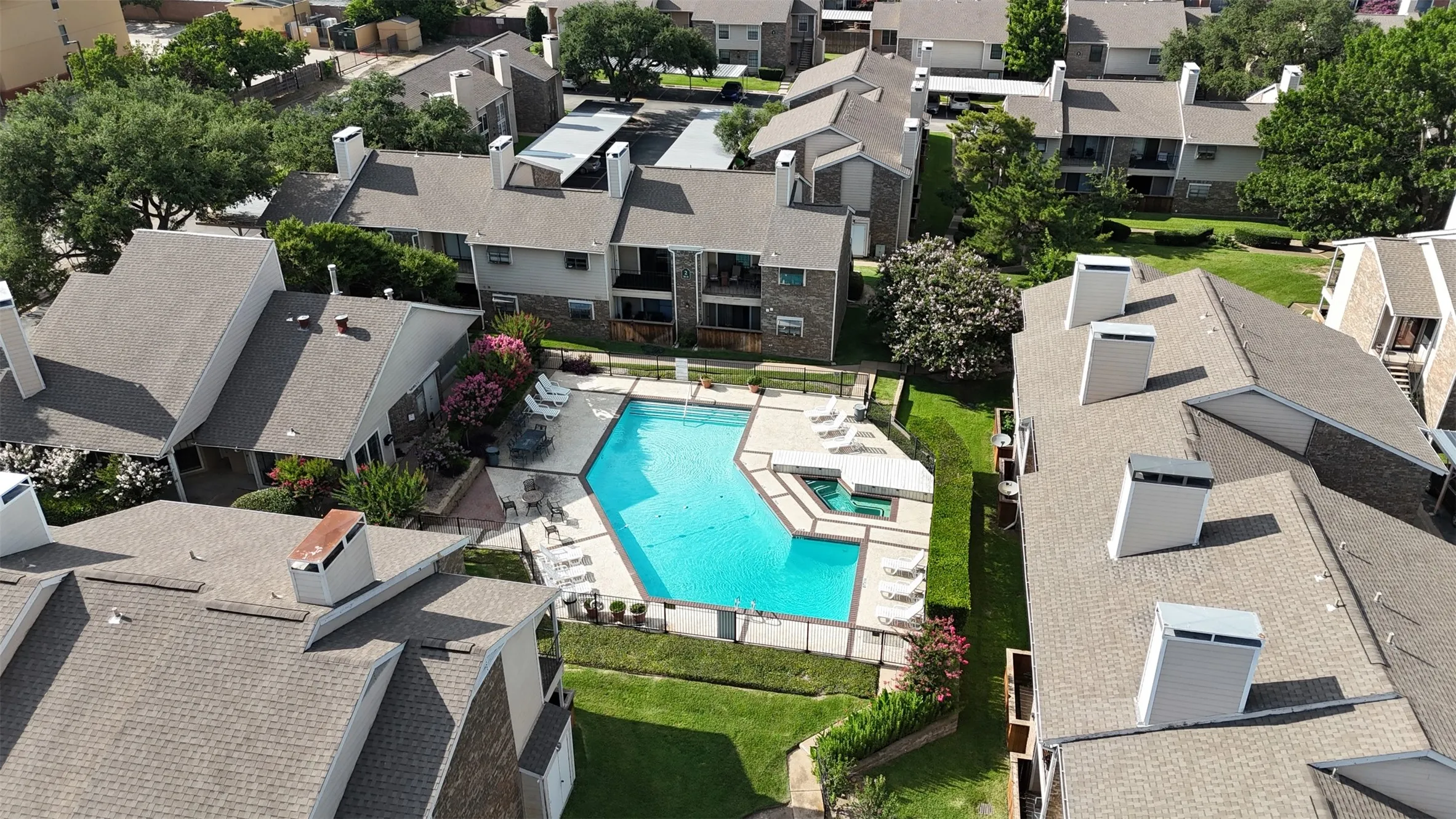 Aerial view of residential area featuring a pool area