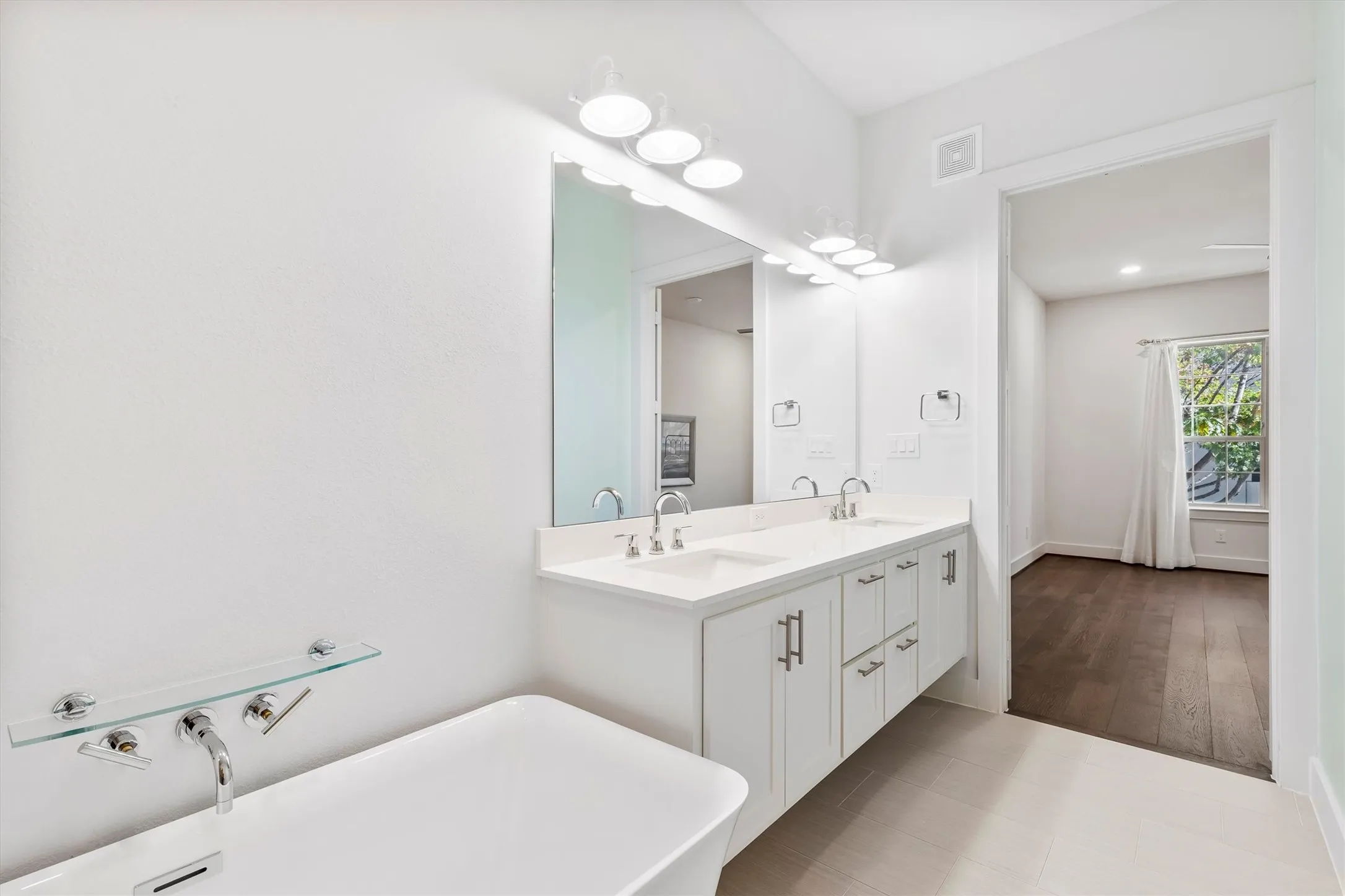 Full bath with a freestanding tub and double vanity