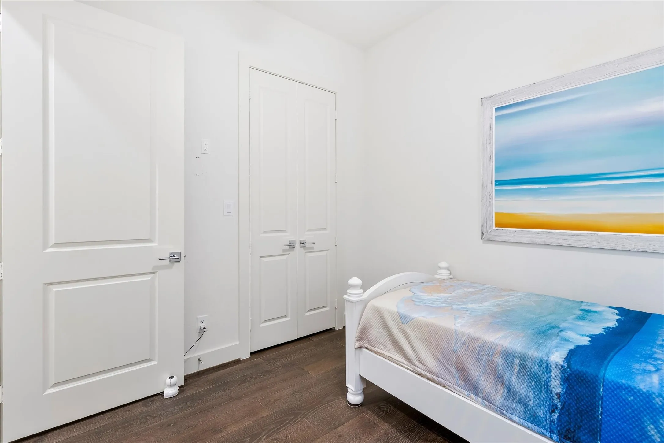 Bedroom featuring dark wood flooring and a closet. *staged to show potential*