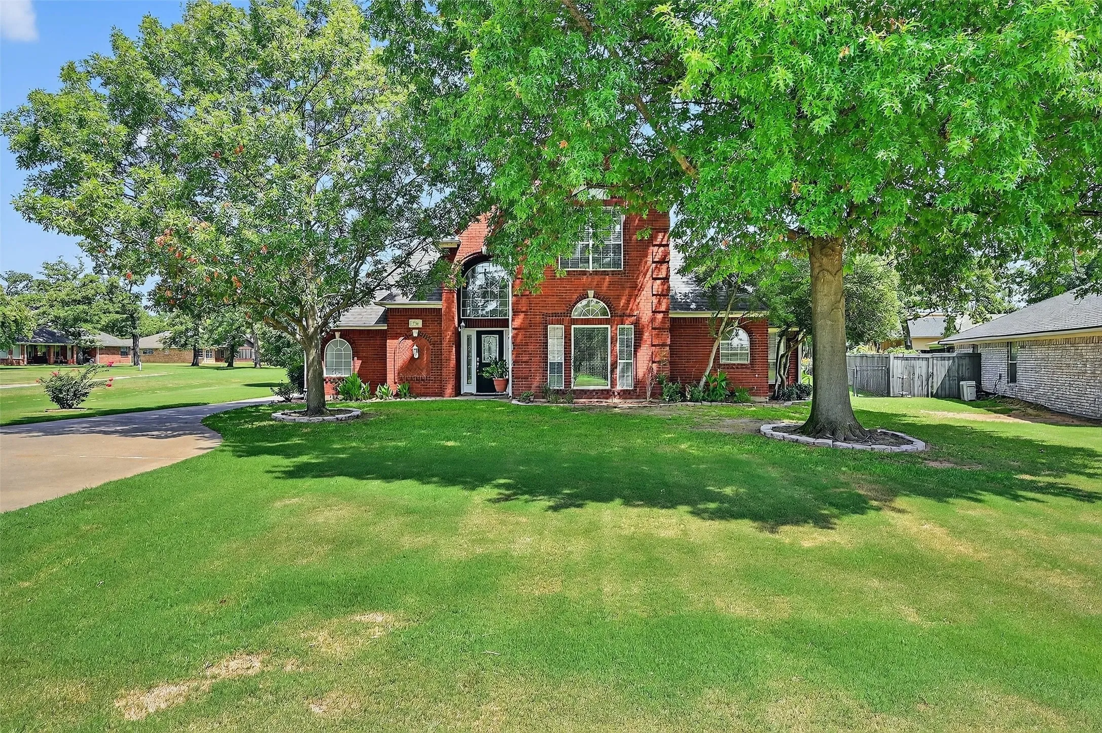 View of front of home featuring brick siding and driveway