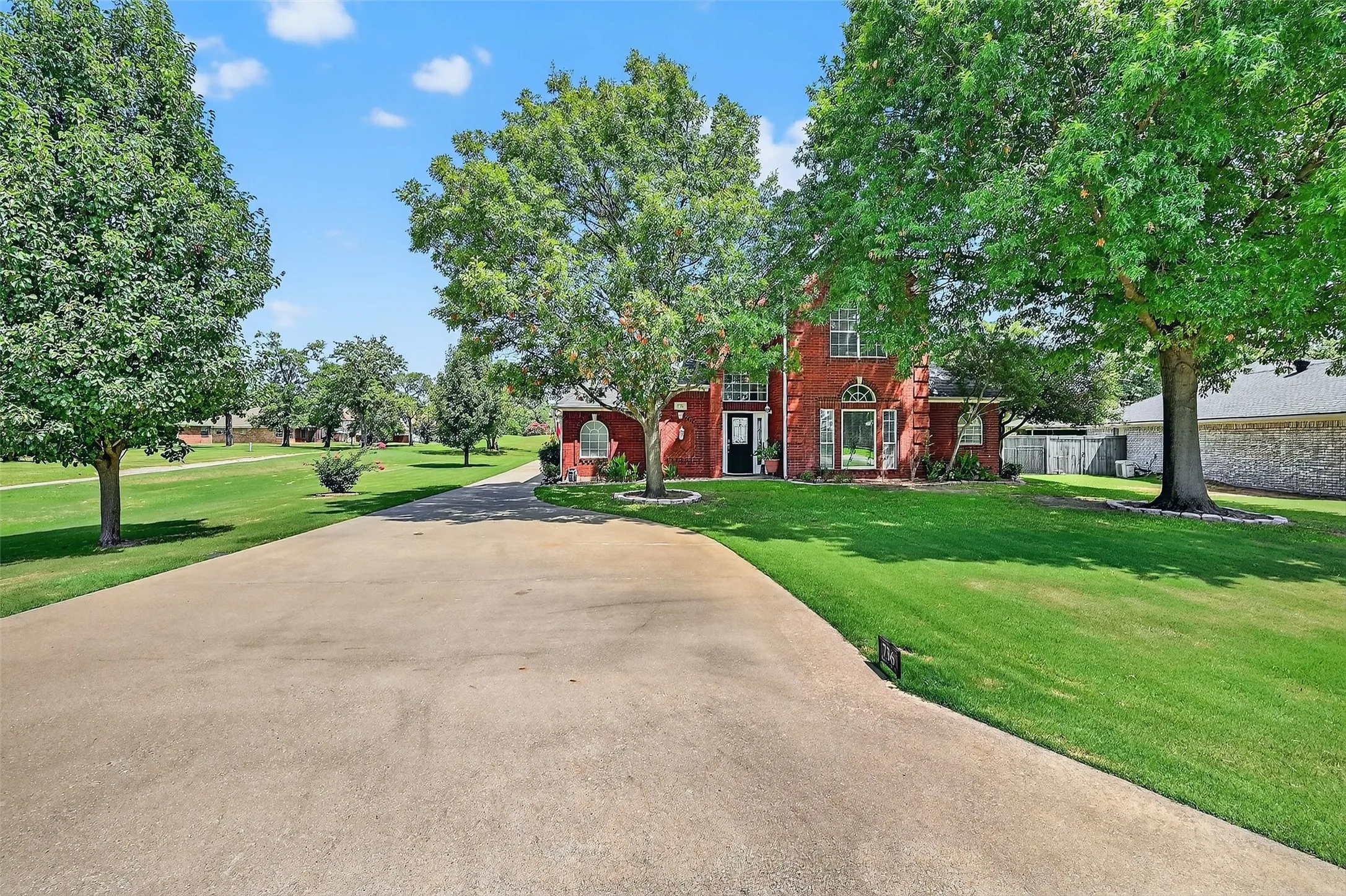 View of front of house with a front lawn and brick siding