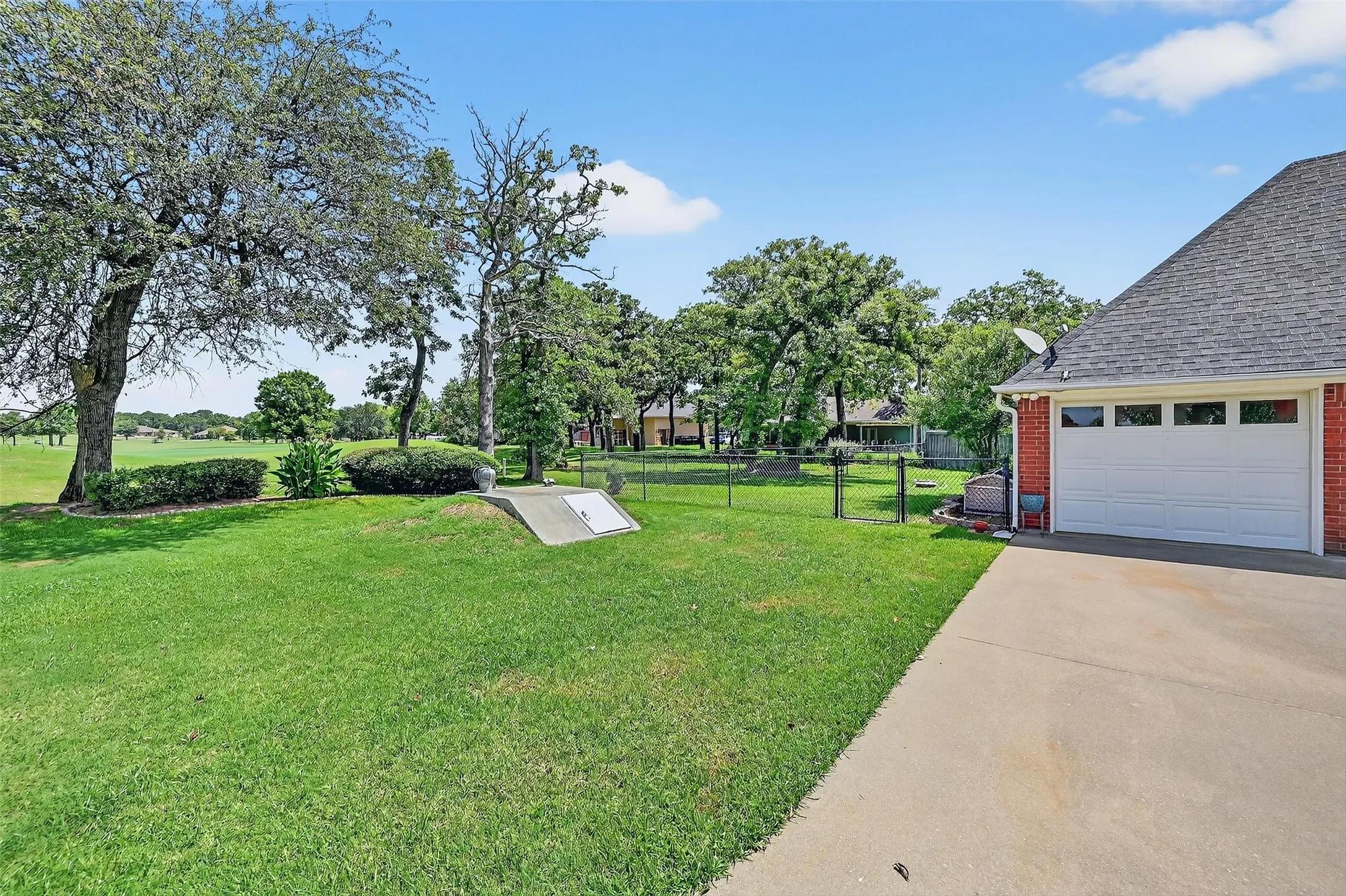 View of yard featuring concrete driveway
