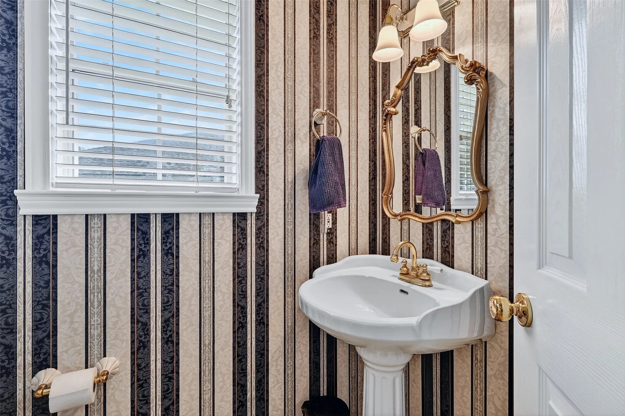 Bathroom featuring wallpapered walls
