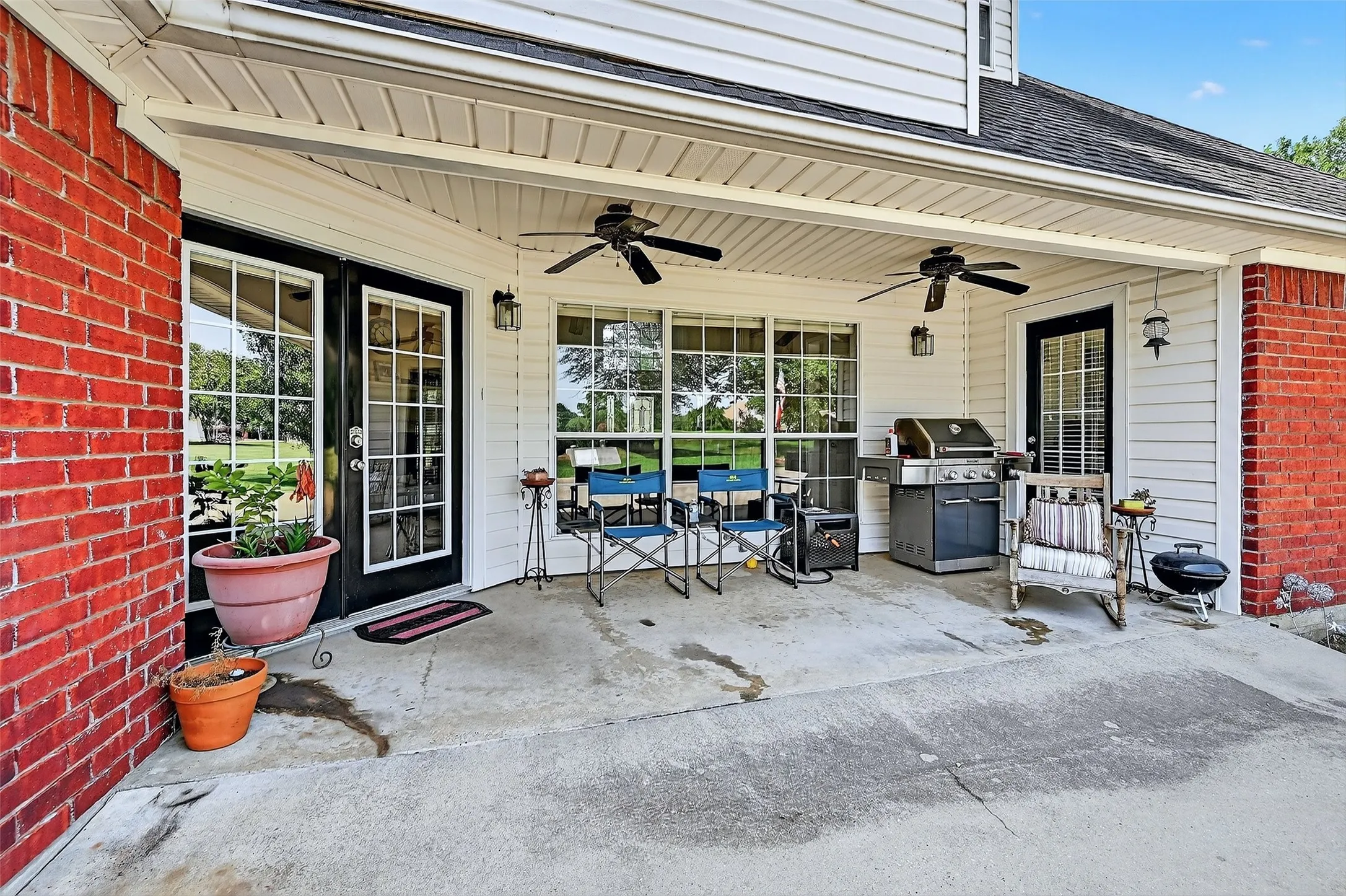 View of patio featuring ceiling fan and a grill