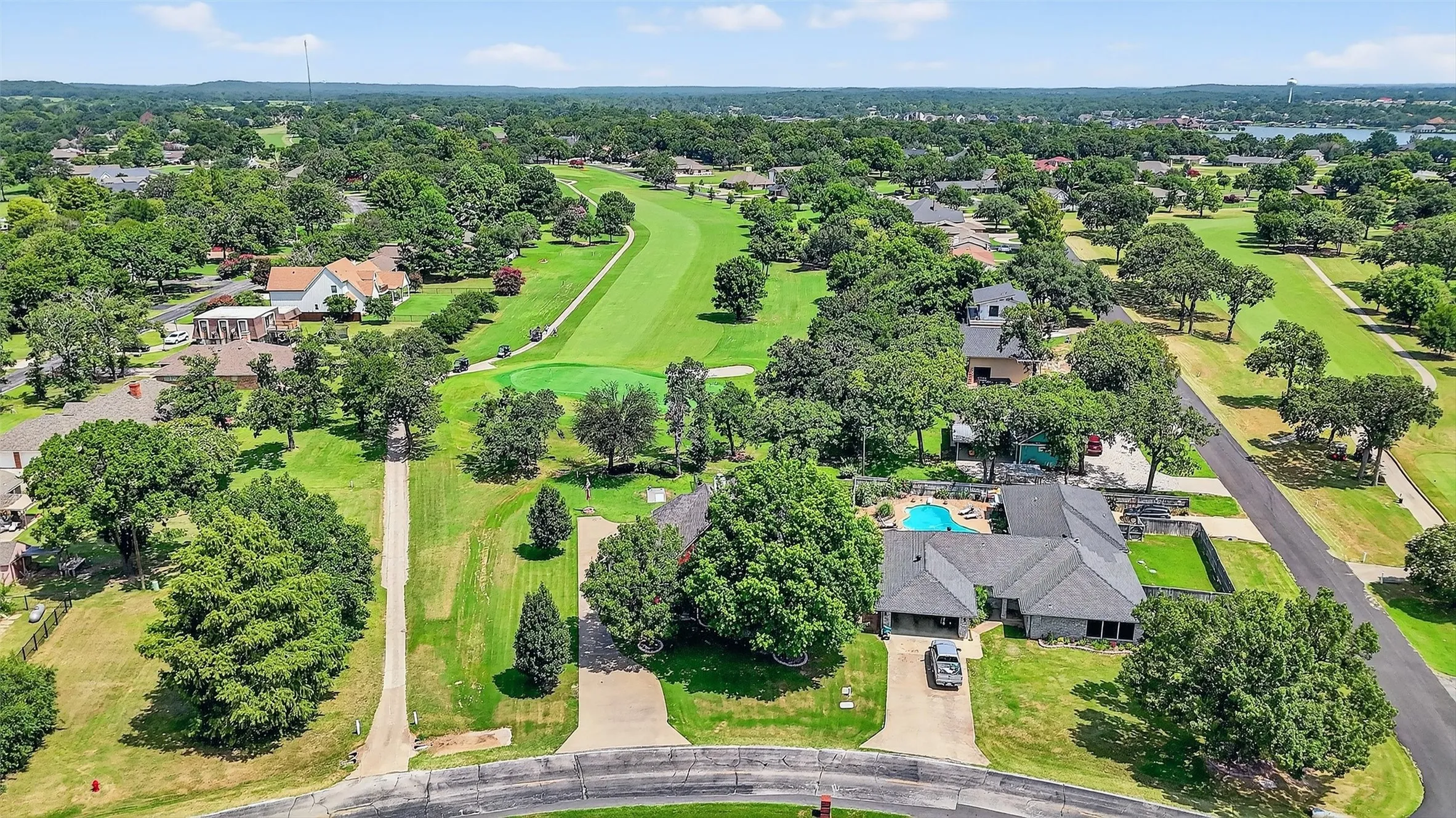 Aerial view of residential area featuring a golf club