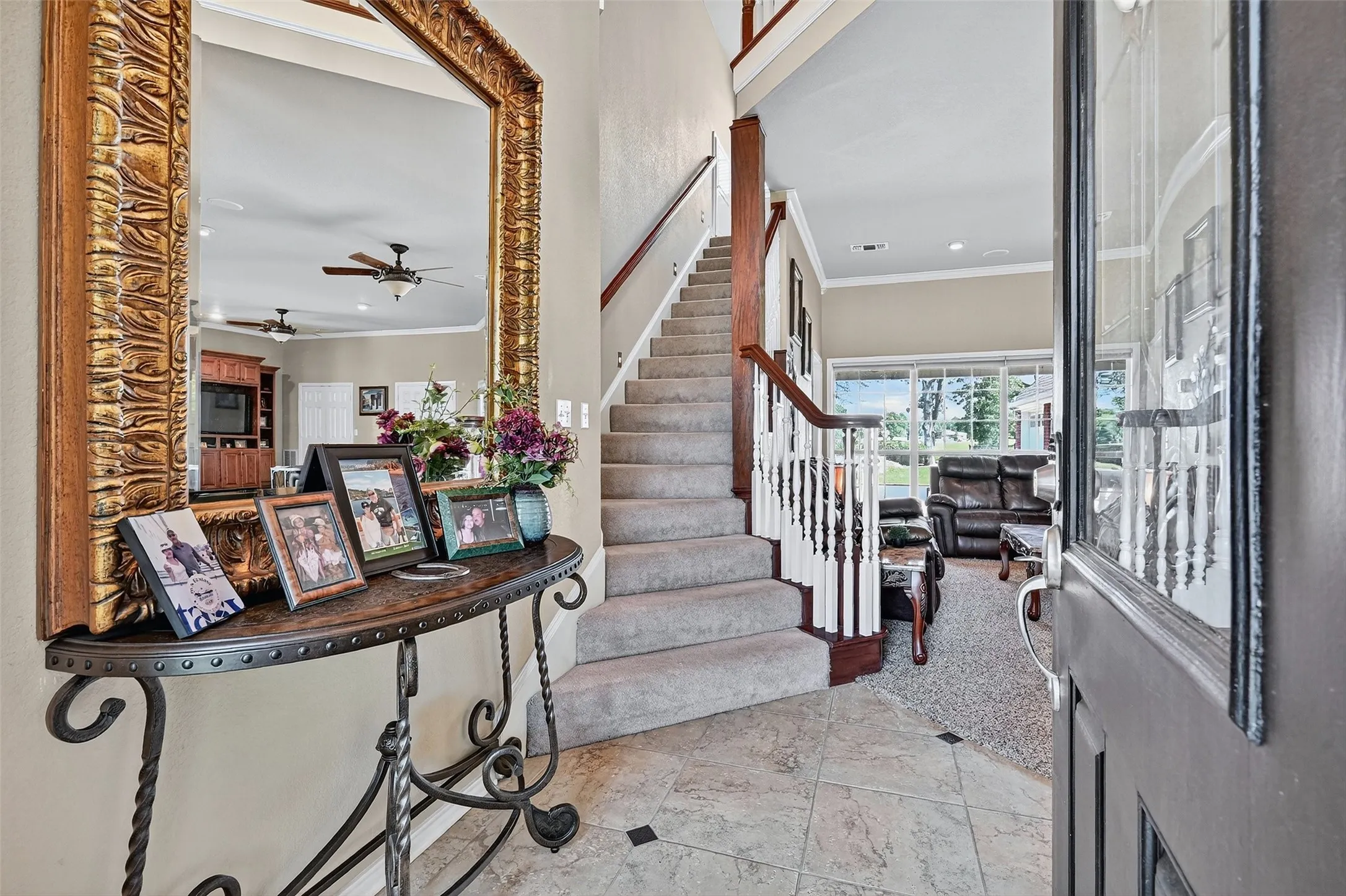 Entryway with ornamental molding, ceiling fan, stairway, and recessed lighting
