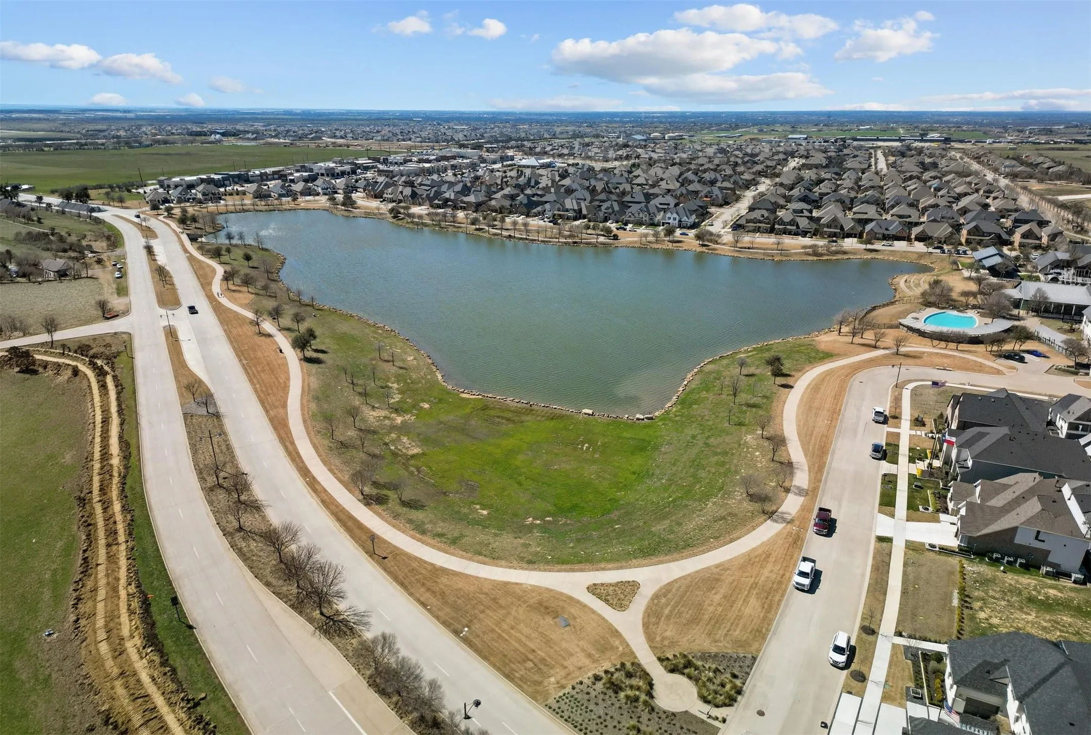Aerial perspective showcasing a lake surrounded by residential properties