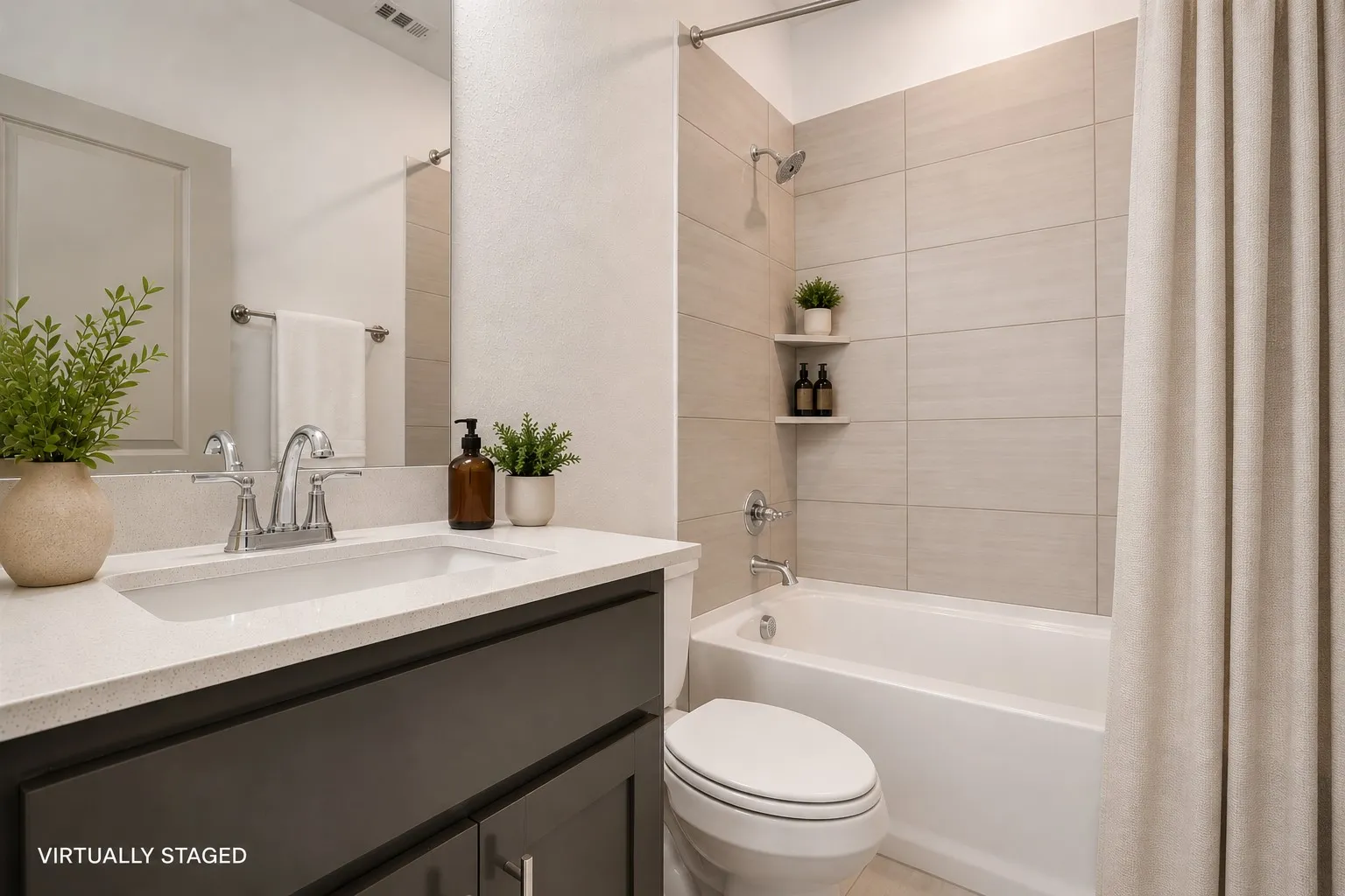 Bathroom featuring a white integrated sink, light-colored countertop, and dark wood-finish vanity
