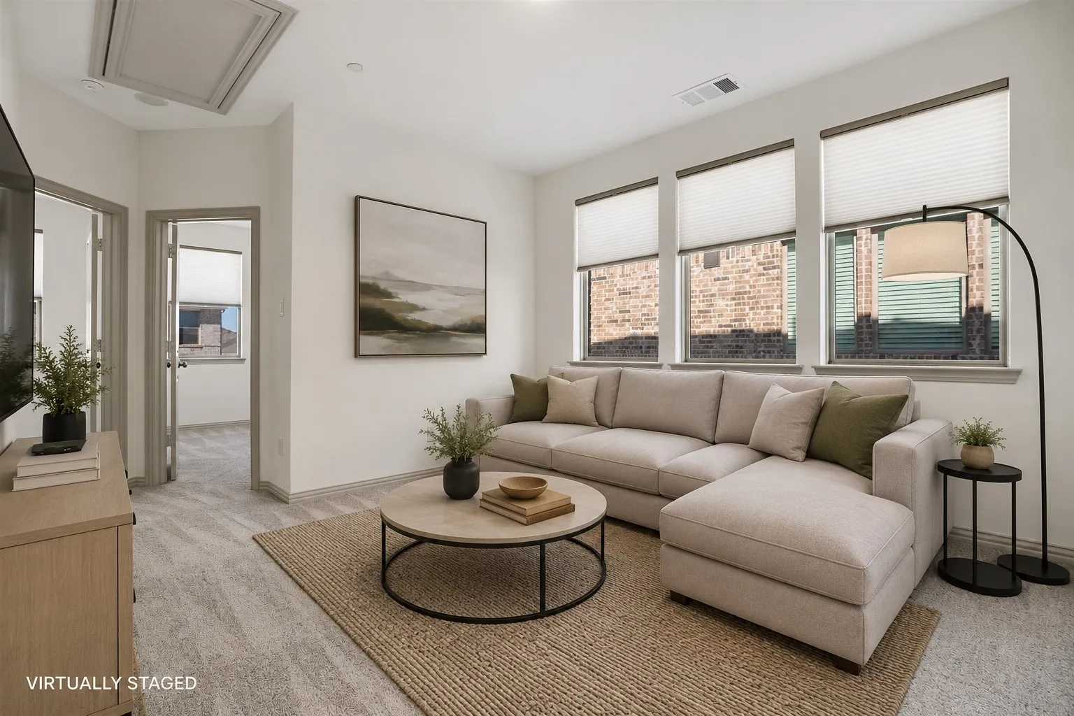 Carpeted living area featuring three large windows with blinds, a ceiling vent, and a built-in access panel