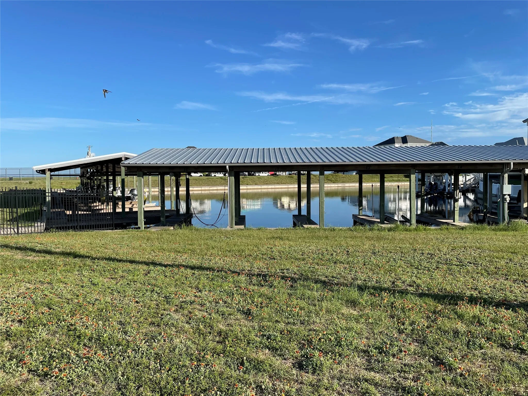 Dock area with a water view and a yard