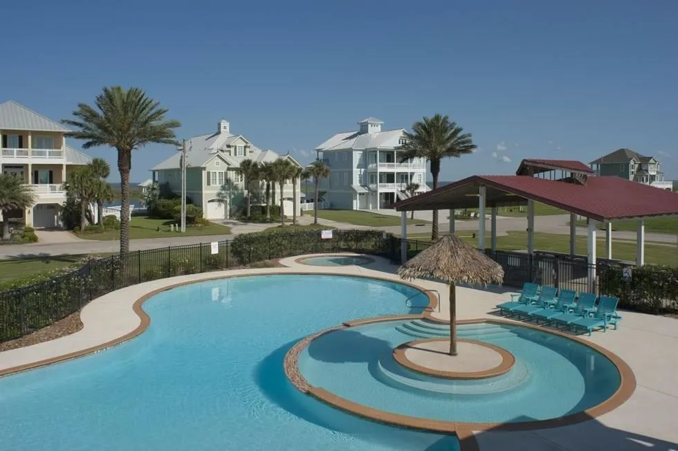 View of swimming pool with a hot tub and a gazebo