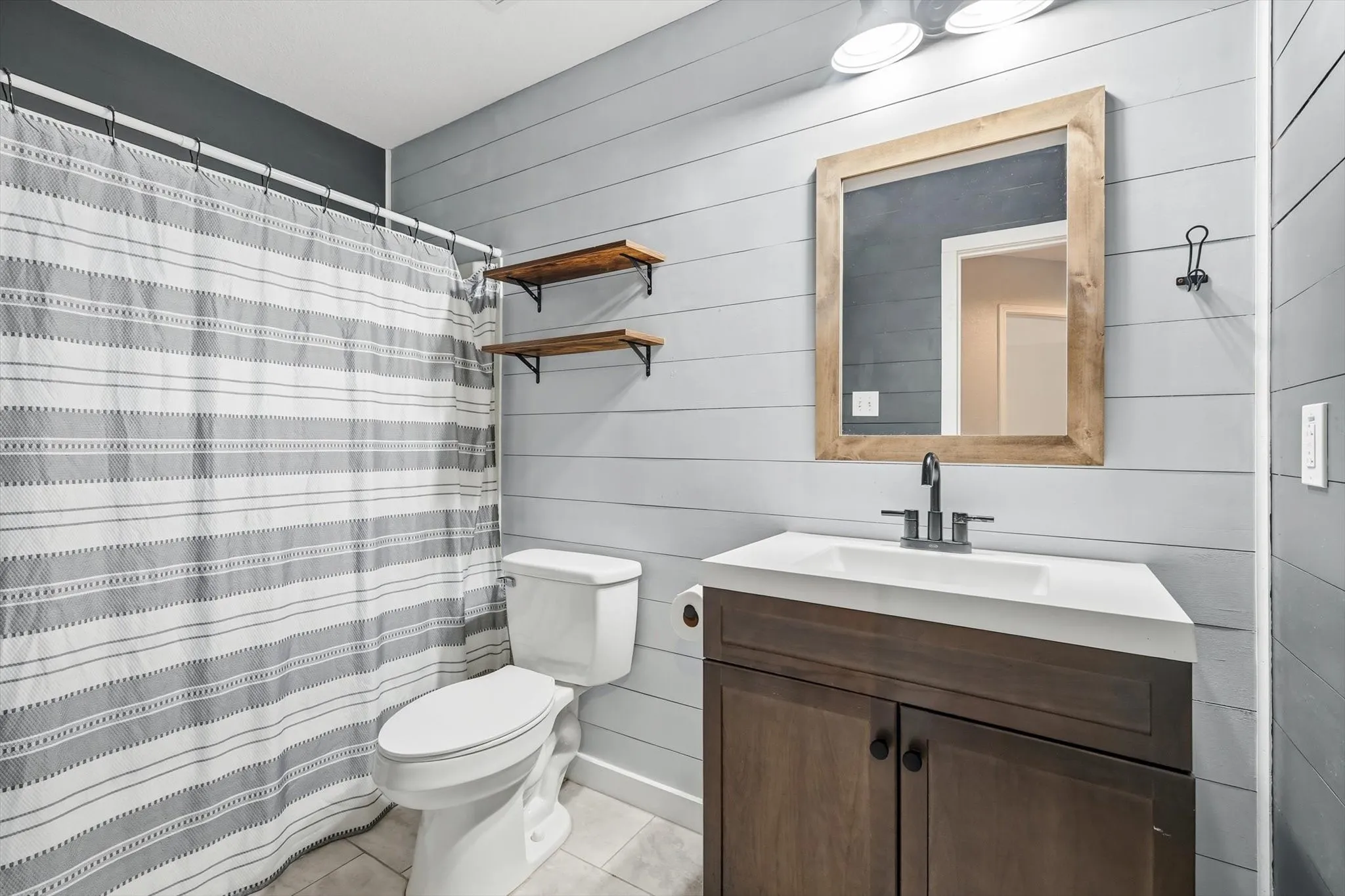 Full bathroom featuring shower / bath combo and vanity
