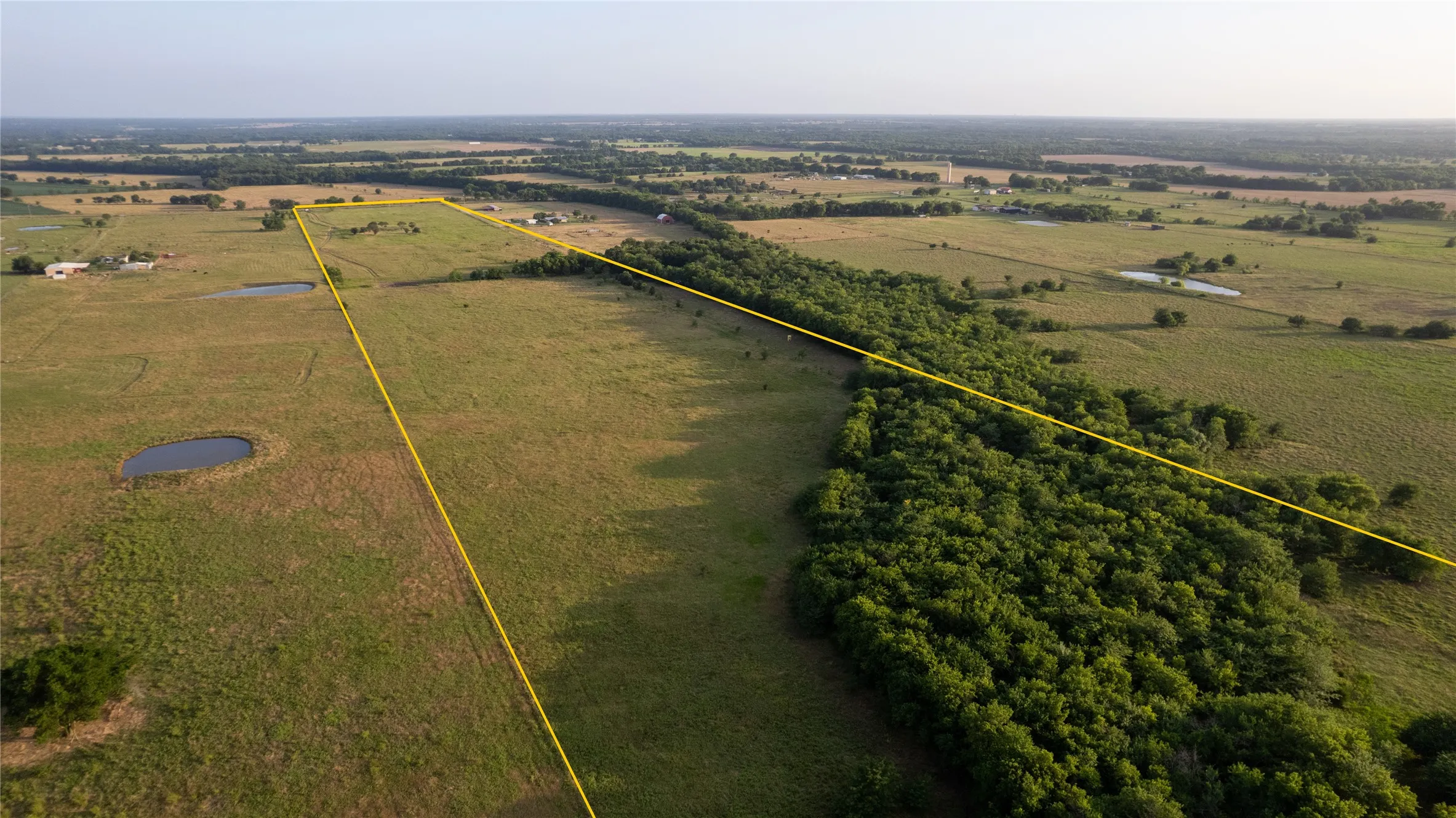 Expansive undeveloped land featuring natural foliage and open grassy areas