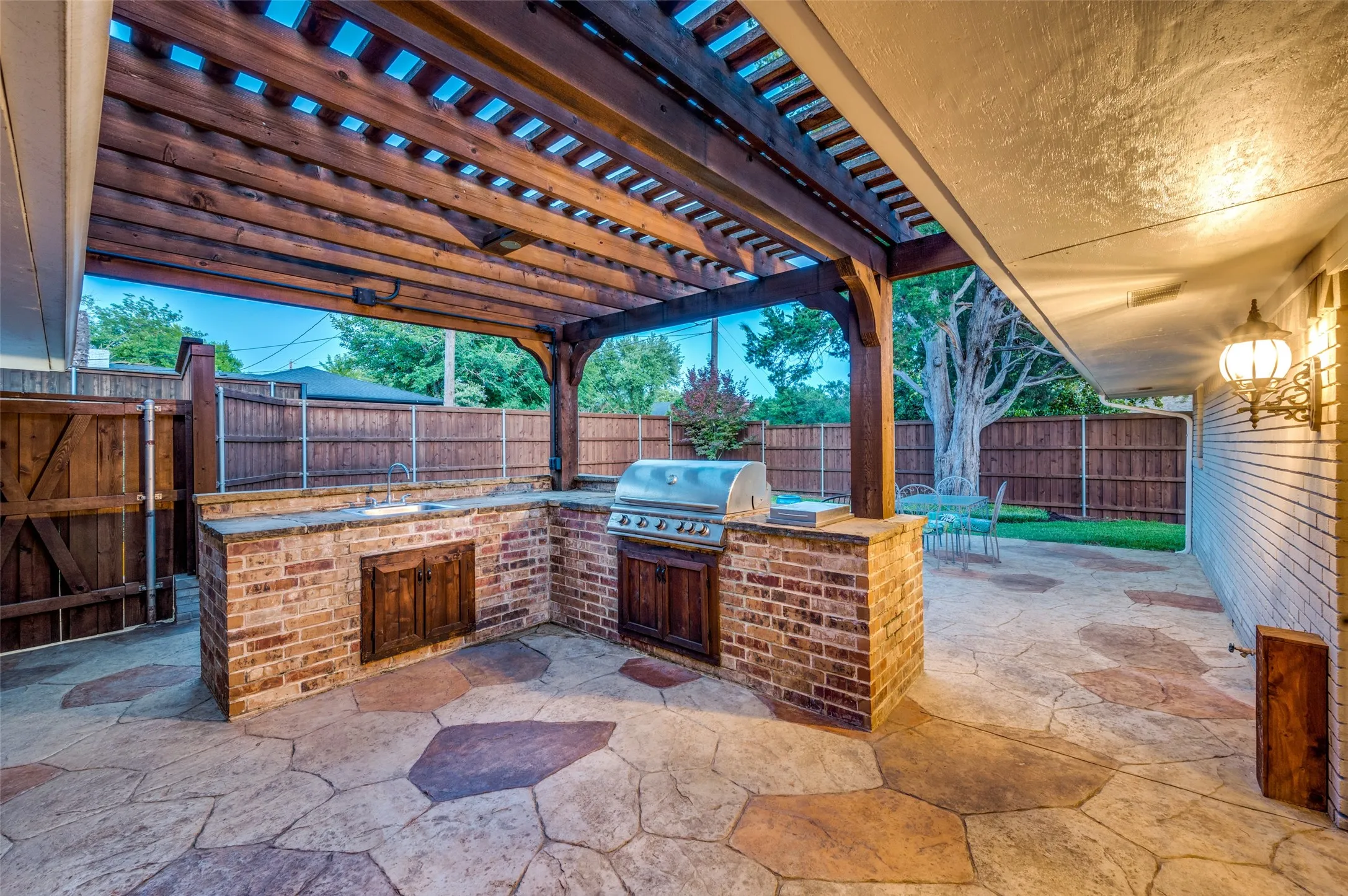 Fenced backyard featuring area for grilling, a patio, and a pergola