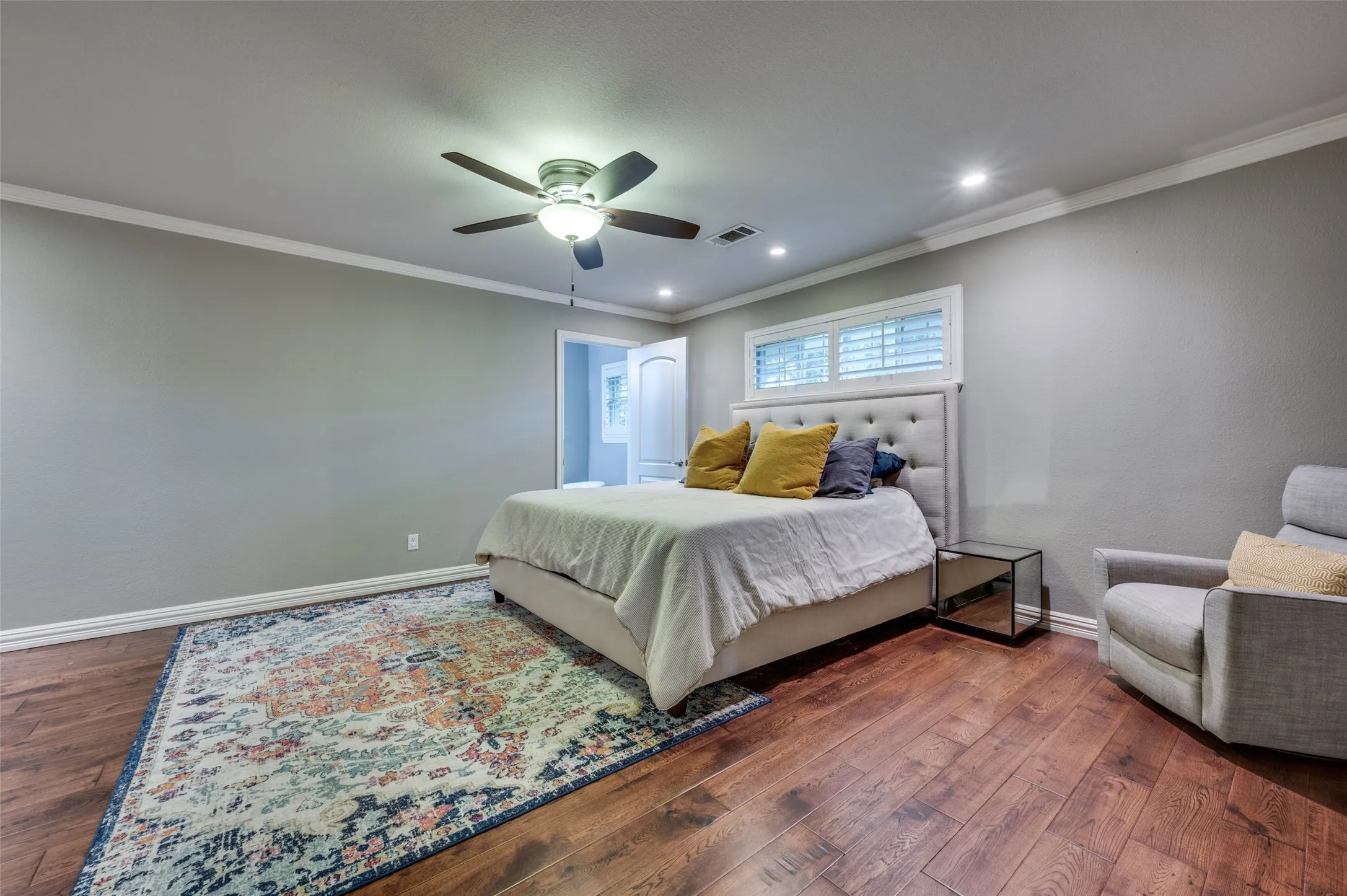 Bedroom featuring dark wood-style floors, ornamental molding, recessed lighting, and a ceiling fan