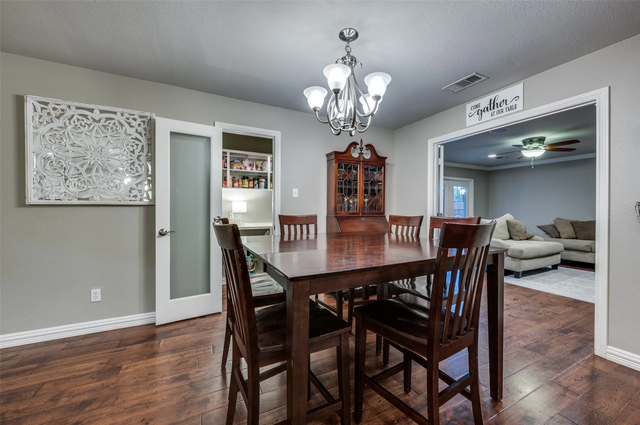 Dining space with a chandelier, dark wood-type flooring, and ceiling fan