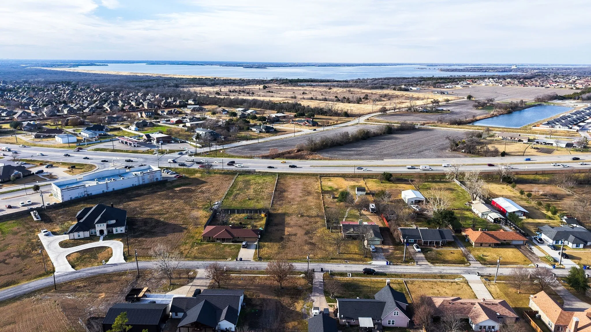 Aerial overview of property's location with nearby suburban area and a large body of water