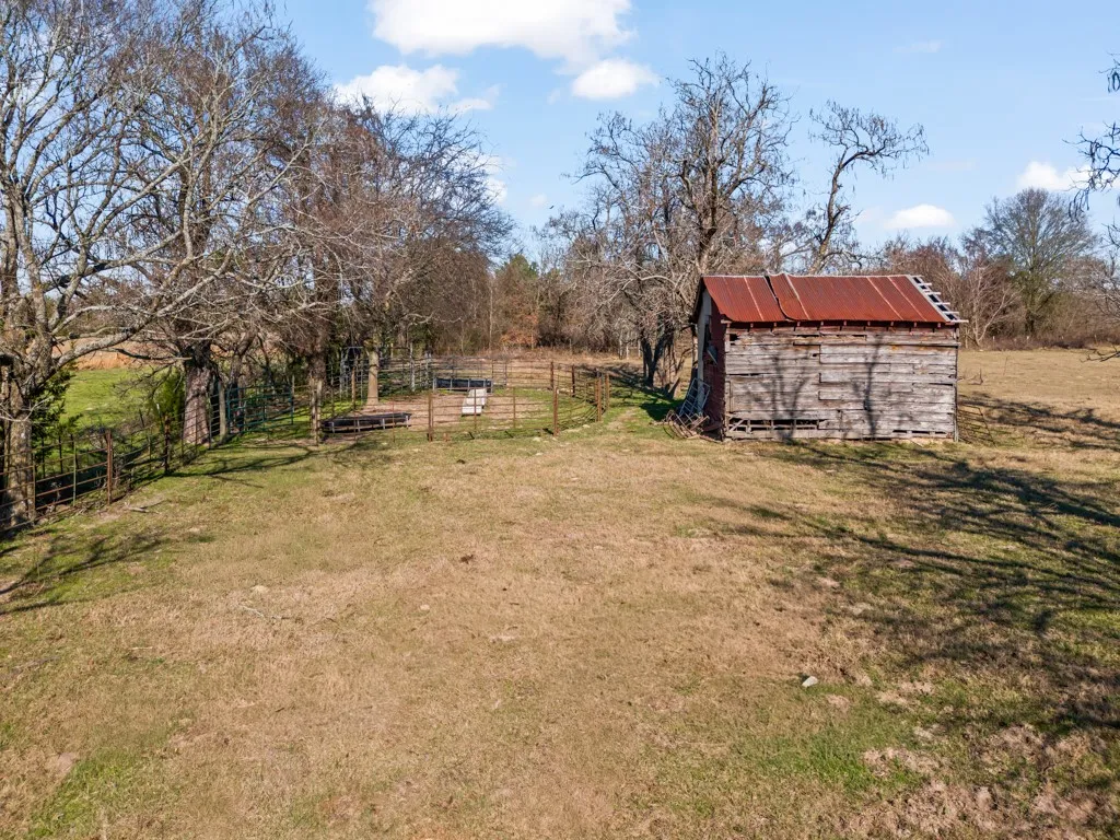 View of yard with an outdoor structure and a rural view
