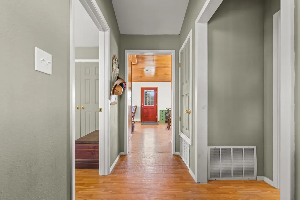 Corridor featuring light wood-type flooring and baseboards