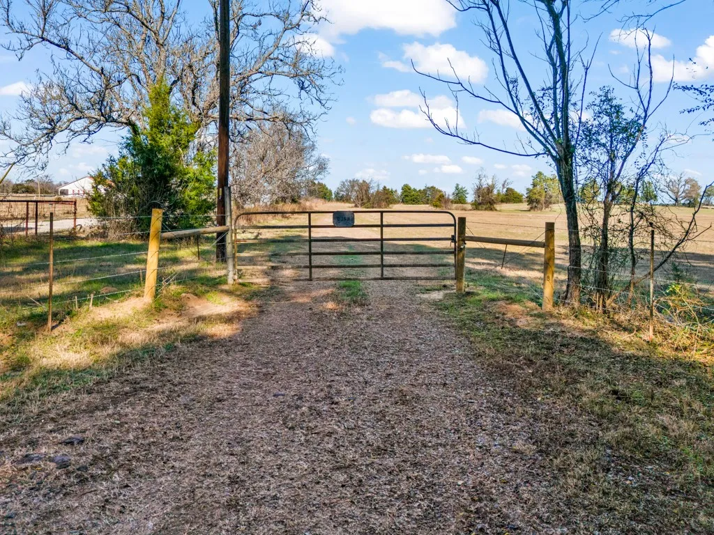 View of property featuring a gate and a view of rural / pastoral area