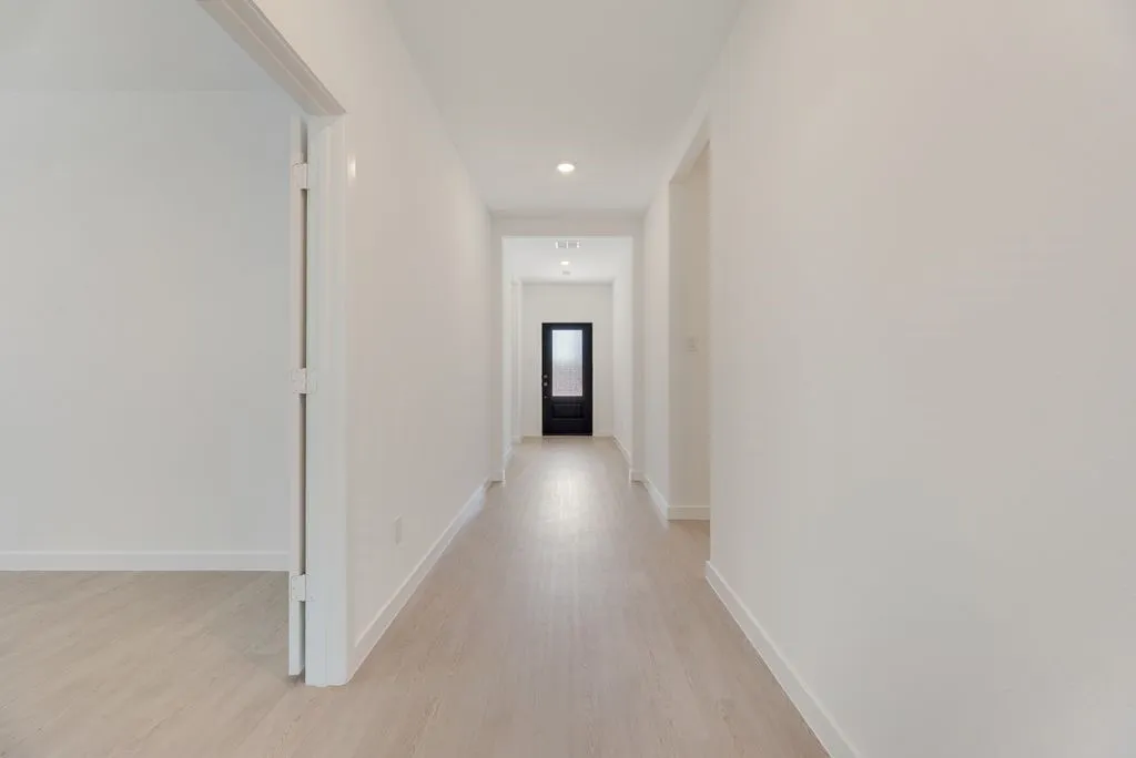 Hallway featuring light wood-style floors and recessed lighting