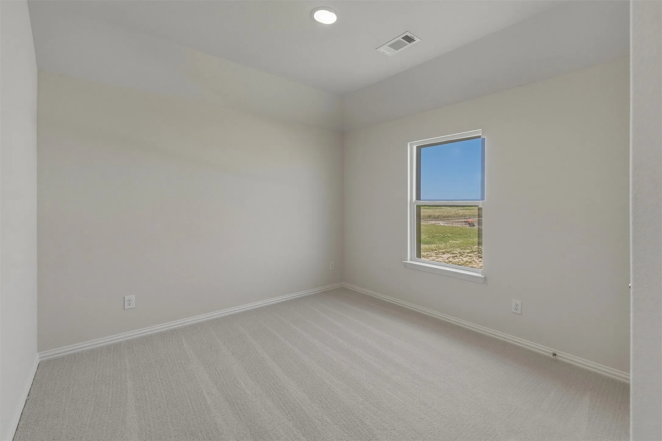 Room featuring light-colored walls, recessed lighting, and a single window with a white frame